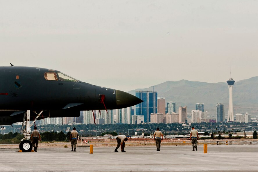 Airmen from Dyess Air Force Base, Texas, walk their section of the flight line for debris that could do damage to aircraft during a Green Flag exercise May 21, 2013, at Nellis Air Force Base, Nev. Before each launch, the Airmen of the 7th Aircraft Maintenance Squadron check their sections for debris. (U.S. Air Force photo/Senior Airman Daniel Hughes) 
