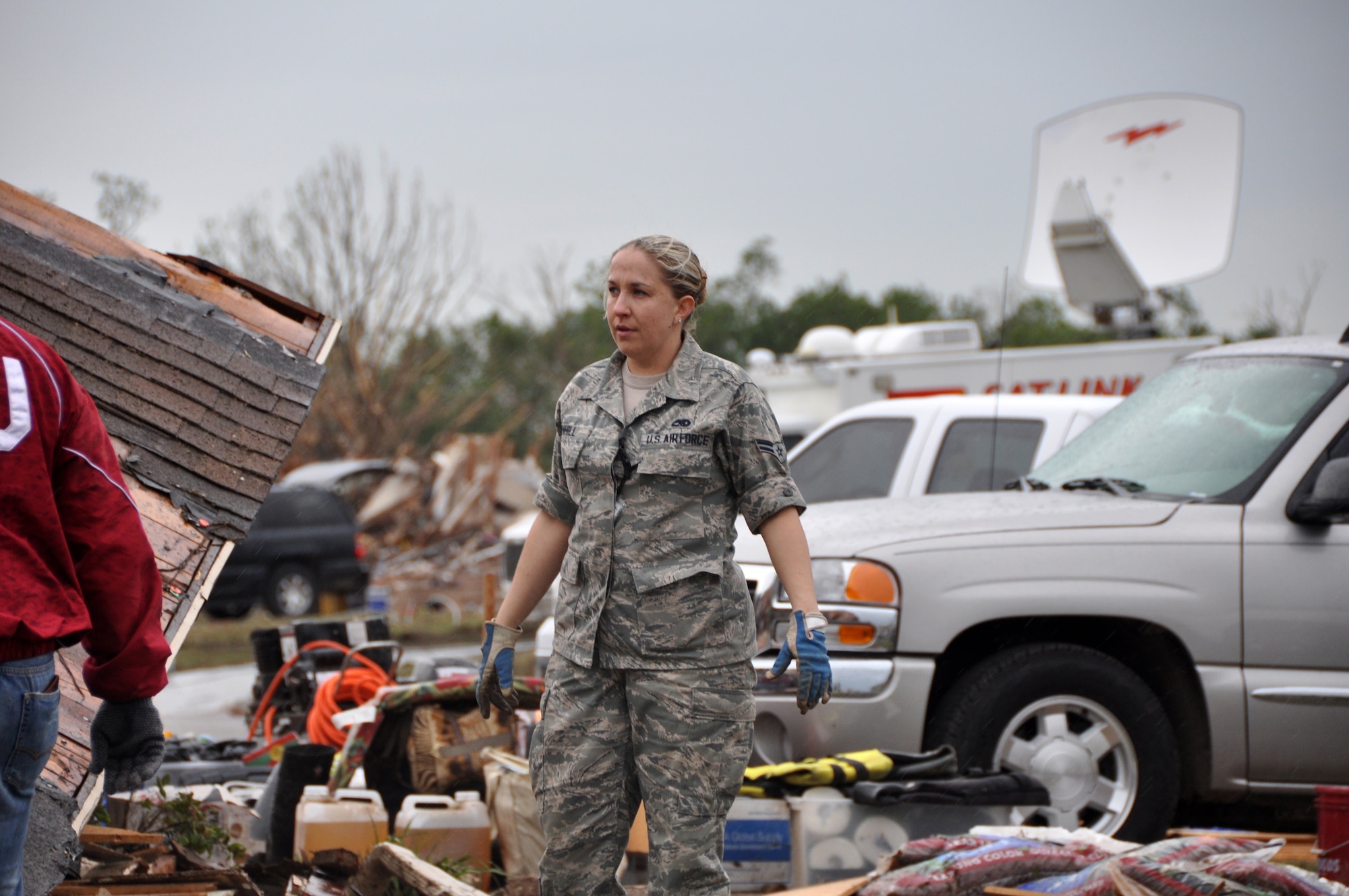 Airman 1st Class Tracy Barnhill, 137th Maintenance Group surveys the damage of her mother’s house after devastating tornado hit the homes of those living in Moore, Okla., May 20, 2013. (U.S. Air Force photo by Senior Airman Mark Hybers)