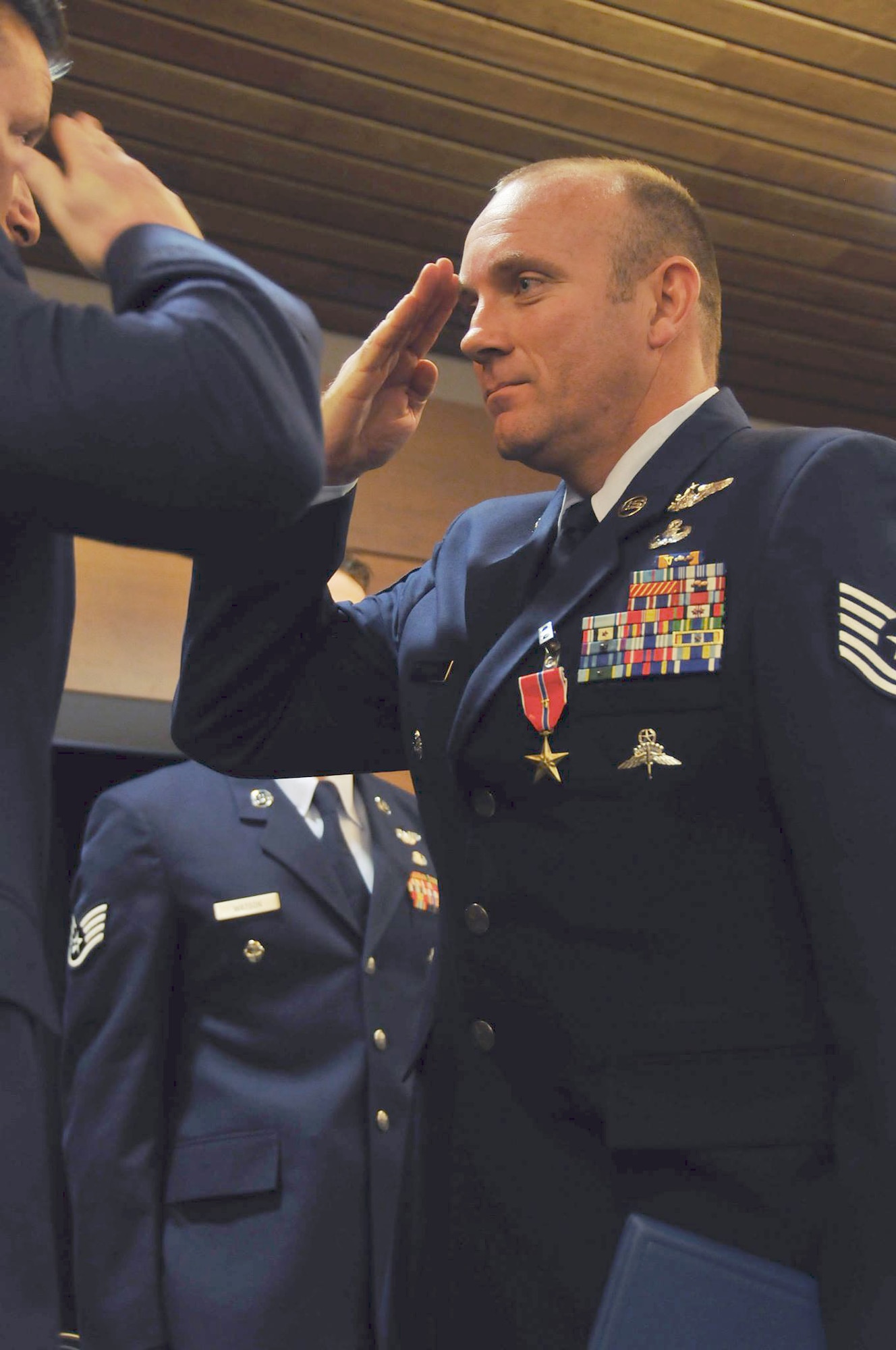 JOINT BASE ELMENDORF-RICHARDSON, Alaska -- Tech. Sgt. Christopher Harding, a pararescueman from the 212 Rescue Squadron, salutes his commander, Maj. Joseph Conroy, after recieving a Bronze Star Medal. One Silver Star Medal and six Bronze Star Medals were handed out here May 18 to men of valor from the Alaska Air National Guard's 212 Rescue Squadron. The medals were presented for actions from the 212 Rescue Squadron's deployments in 2011 and 2012.  National Guard photo by Staff Sgt. N. Alicia Goldberger.