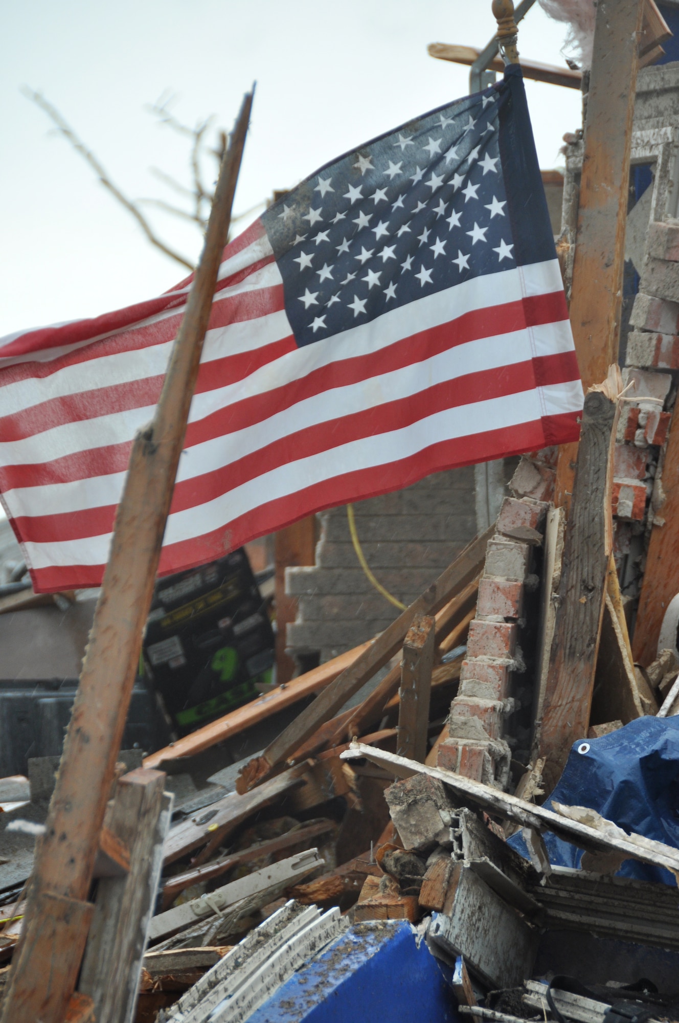 A United States flag flies from the ruble of a home destroyed in Moore, Okla. A powerful EF-5 tornado touched down approximately three miles south of Tinker AFB. (U.S. Air Force photo by Maj. Jon Quinlan)