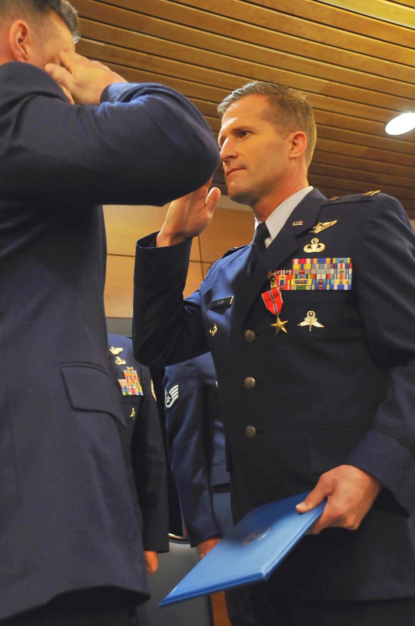 JOINT BASE ELMENDORF-RICHARDSON, Alaska -- Capt. Christopher Keen, a pararescueman from the 212 Rescue Squadron, salutes his commander, Maj. Joseph Conroy, after recieving a Bronze Star Medal. One Silver Star Medal and six Bronze Star Medals were handed out here May 18 to men of valor from the Alaska Air National Guard's 212 Rescue Squadron. The medals were presented for actions from the 212 Rescue Squadron's deployments in 2011 and 2012.  National Guard photo by Staff Sgt. N. Alicia Goldberger.