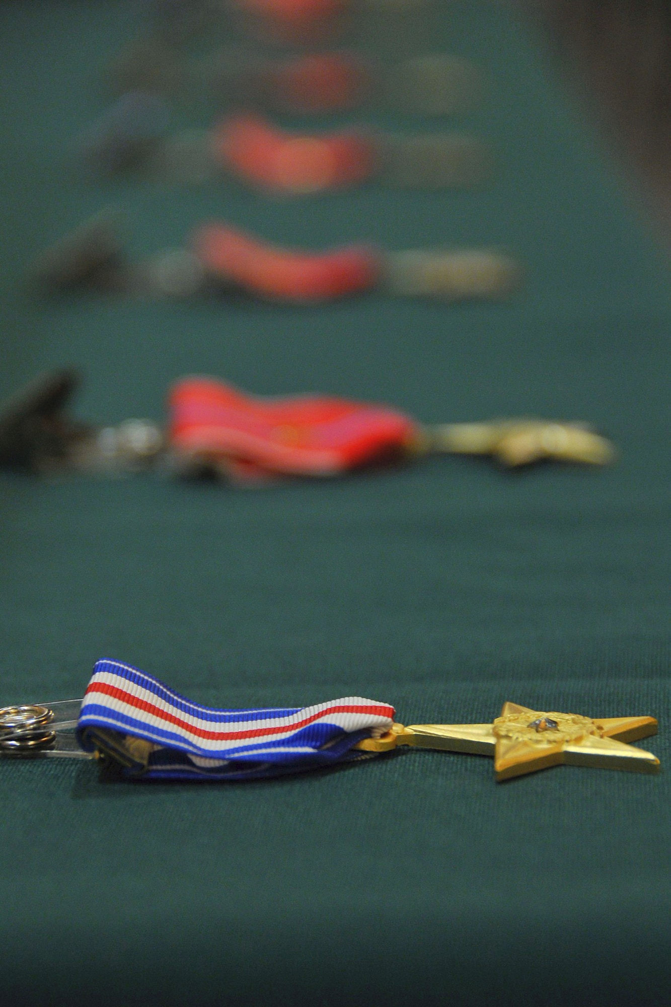 JOINT BASE ELMENDORF-RICHARDSON, Alaska -- One Silver Star Medal and six Bronze Star Medals lay ready here May 18 to go to men of valor from the Alaska Air National Guard's 212 Rescue Squadron. The medals were presented for actions from the 212 Rescue Squadron's deployments in 2011 and 2012. National Guard photo by Staff Sgt. N. Alicia Goldberger.