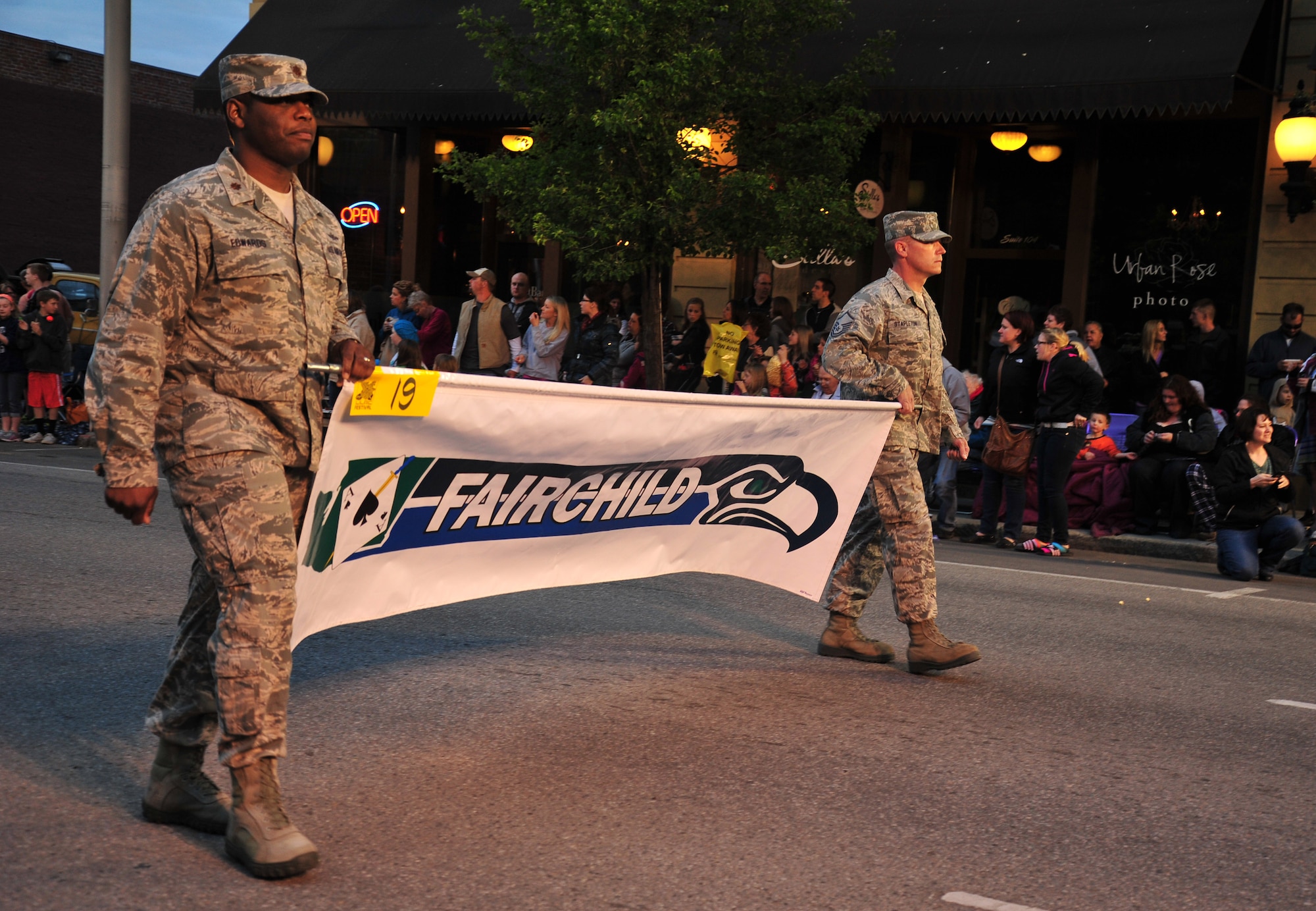 Airmen from Fairchild Air Force Base display a banner with the base’s logo during the Lilac Festival’s Armed Forces Torchlight Parade in Spokane, Wash., May 18, 2013. The parade is considered the nation’s largest Torchlight Parade on Armed Forces Day. (U.S. Air Force photo by Senior Airman Taylor Curry)
