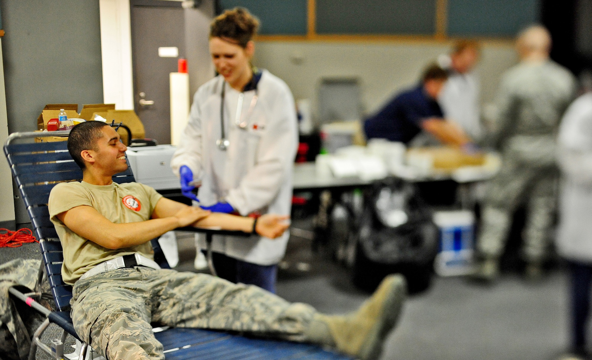 Airman 1st Class Randolph Baez, 509th Civil Engineer Squadron blood donor, shares a laugh with Deb Stewart, American Red Cross collection technician, as she processes his blood at an American Red Cross blood drive at Whiteman Air Force Base, Mo., May 16, 2013. The American Red Cross supplies more than 40 percent of America’s blood supply and provides blood for patients in more than 3,000 hospitals across the U.S. (U.S. Air Force photo by Staff Sgt. Nick Wilson/Released)