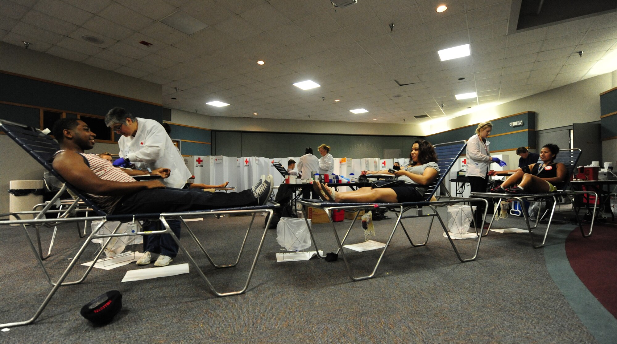 Volunteers donate pints of blood during an American Red Cross blood drive at Whiteman Air Force Base, Mo., May 16, 2013. With a mission to provide life-saving blood to patients in times of crises and disasters, the American Red Cross is the largest supplier of blood in the U.S. (U.S. Air Force photo by Staff Sgt. Nick Wilson/Released)