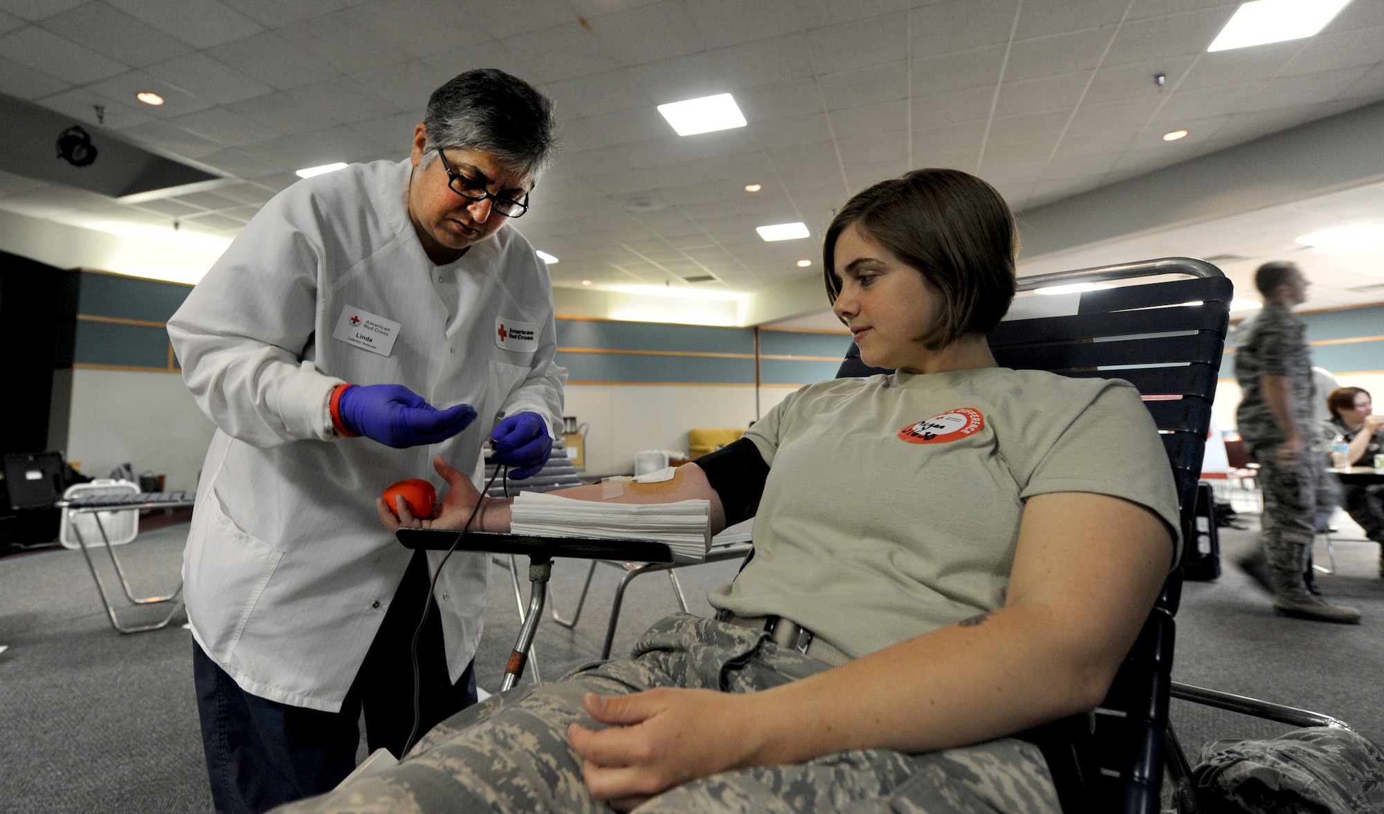 Airman 1st Class Megan Gvozd, 509th Civil Engineer Squadron blood donor, gets her blood taken by Linda Schandura, American Red Cross collection technician, during a blood drive at Whiteman Air Force Base, Mo., May 16, 2013. The American Red Cross has a mission to provide life-saving blood products to medical patients and members of the Armed Forces in times of emergencies, crises and disasters. (U.S. Air Force photo by Staff Sgt. Nick Wilson/Released)