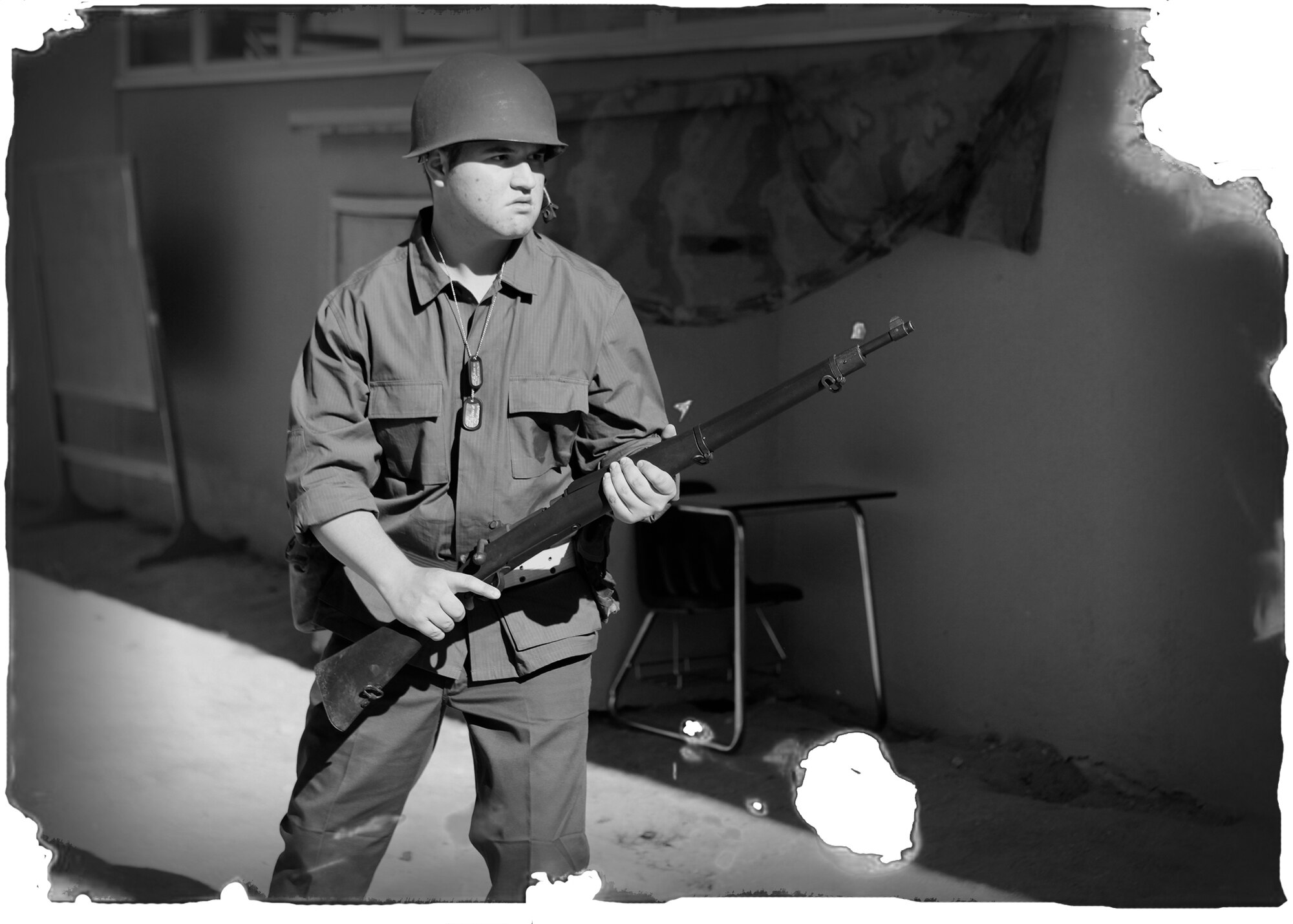 Graphically enhanced photo of Michael Bromsey, Desert High School junior, who was re-enacting a World War II-era soldier during a "Night at the Museum" event hosted by the students and faculty of Desert Junior Senior High School May 20. The event was an end-of-year, school-wide project where students transformed the halls of the high school into static displays, living statues and and interactive history exhibits. (U.S. Air Force graphic by Jet Fabara)