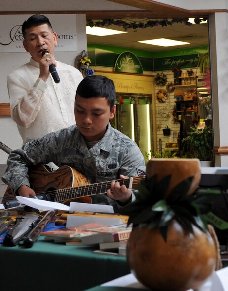 Senior Airman Rodolfo Prudente (right), 28th Force Support Squadron services technician, plays guitar while Master Sgt. Bernhard Amargo, 28th Maintenance Squadron programs flight chief, sings a traditional Filipino song during the Asian Pacific Heritage Month celebration at The Exchange at Ellsworth Air Force Base, S.D., May 15, 2013.  The traditional Filipino song is sung as a serenade to express one’s love for another. (U.S. Air Force photo by Airman 1st Class Anania Tekurio/Released)