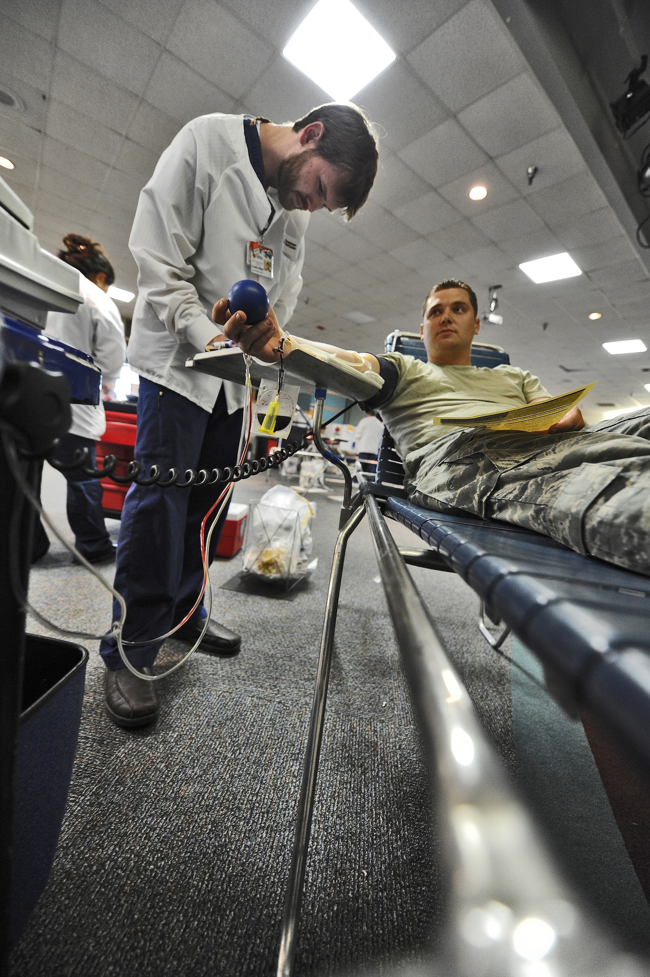 Clark Merle, American Red Cross collection technician, takes notes as his volunteer donor, Senior Airman Jeffrey Ferguson of the 442nd Maintenance Squadron, gives a pint of blood during a blood drive at Whiteman Air Force Base, Mo., May 16, 2013. Volunteers who donate blood can give a maximum of one pint every 56 days. (U.S. Air Force photo by Staff Sgt. Nick Wilson/Released)
