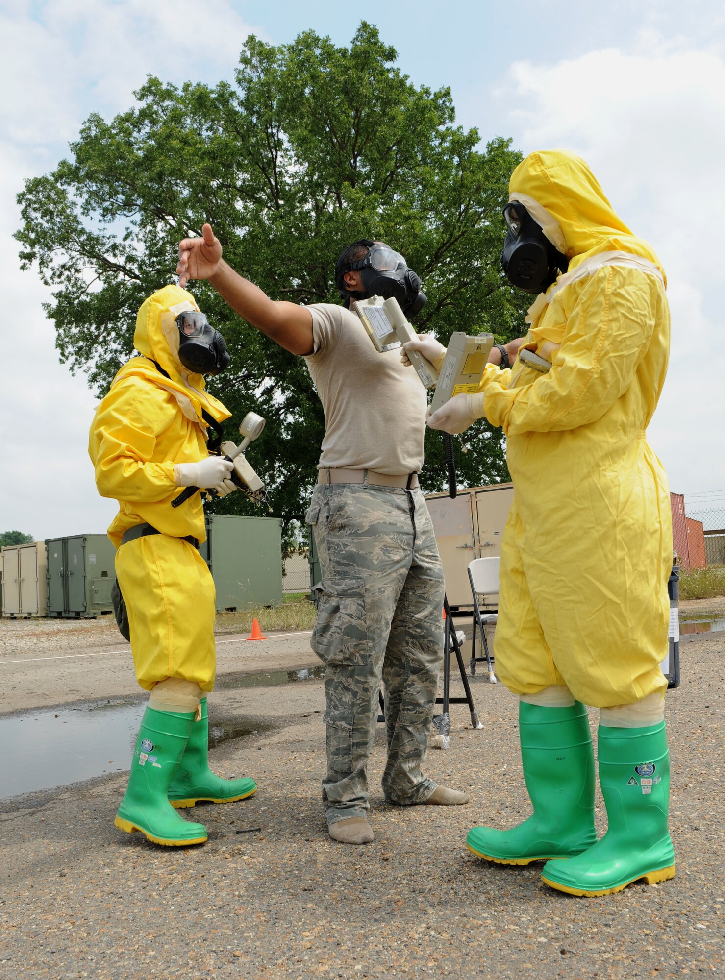 Airmen from the 2nd Civil Engineer Squadron emergency management check Staff Sgt. Robert Miller, 2nd Aerospace Medicine Squadron bioenvironmental, for radiation contamination during a joint exercise on Barksdale Air Force Base, La., May 17, 2013. During the decontamination process, personnel and equipment are thoroughly checked for any contamination. (U.S. Air Force photo/Airman 1st Class Benjamin Gonsier)