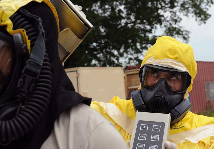 Senior Airman Juan Jose Munoz, 2nd Civil Engineer Squadron emergency management, concentrates while scanning a 2nd CES firefighter for radiation contamination during a joint exercise on Barksdale Air Force Base, La., May 17, 2013. In an incident where hazardous materials are found, emergency responders gauge the incident and setup a decontamination zone, where personnel are thoroughly checked for any kind of contamination. (U.S. Air Force photo/Airman 1st Class Benjamin Gonsier)