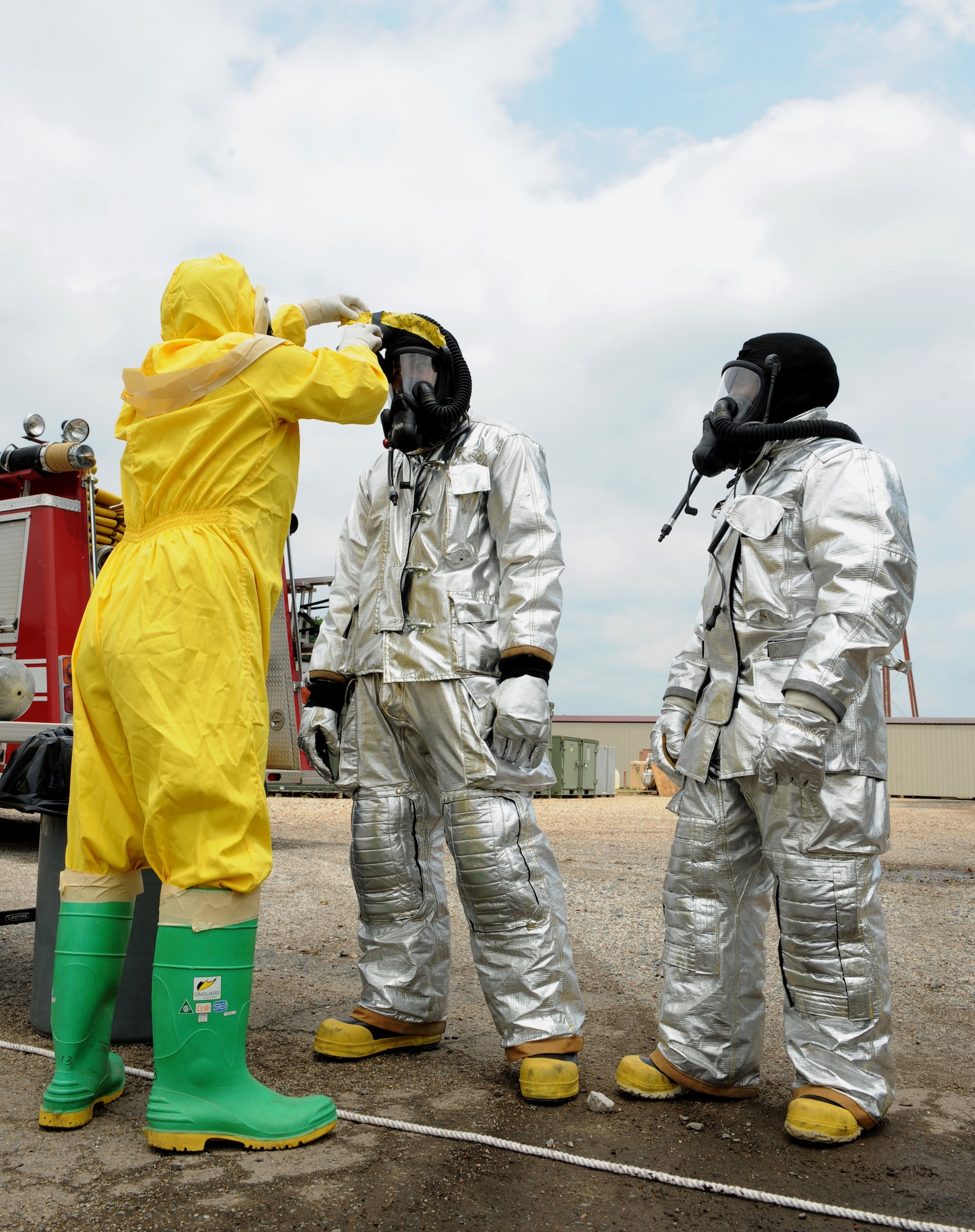 An Airman from the 2nd Civil Engineering Squadron emergency management prepare 2nd CES firefighters for radiation contamination detection during a joint exercise on Barksdale Air Force Base, La., May 17, 2013. The exercise gave emergency personnel hands on experience on how to handle aircraft accidents with strategic weapons on board. (U.S. Air Force photo/Airman 1st Class Benjamin Gonsier)
