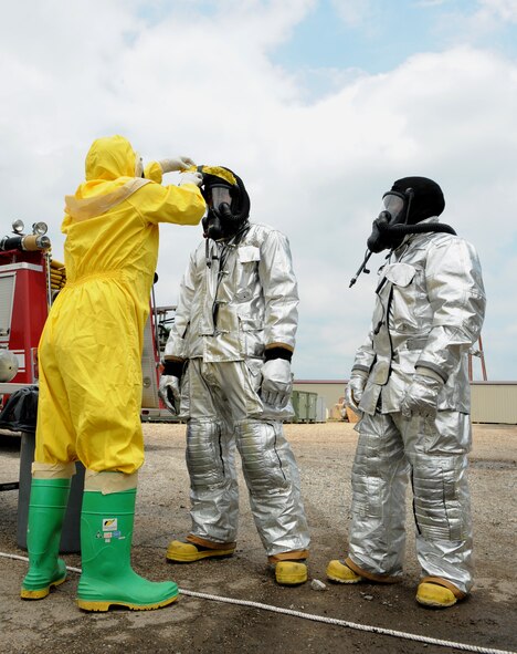 An Airman from the 2nd Civil Engineering Squadron emergency management prepare 2nd CES firefighters for radiation contamination detection during a joint exercise on Barksdale Air Force Base, La., May 17, 2013. The exercise gave emergency personnel hands on experience on how to handle aircraft accidents with strategic weapons on board. (U.S. Air Force photo/Airman 1st Class Benjamin Gonsier)