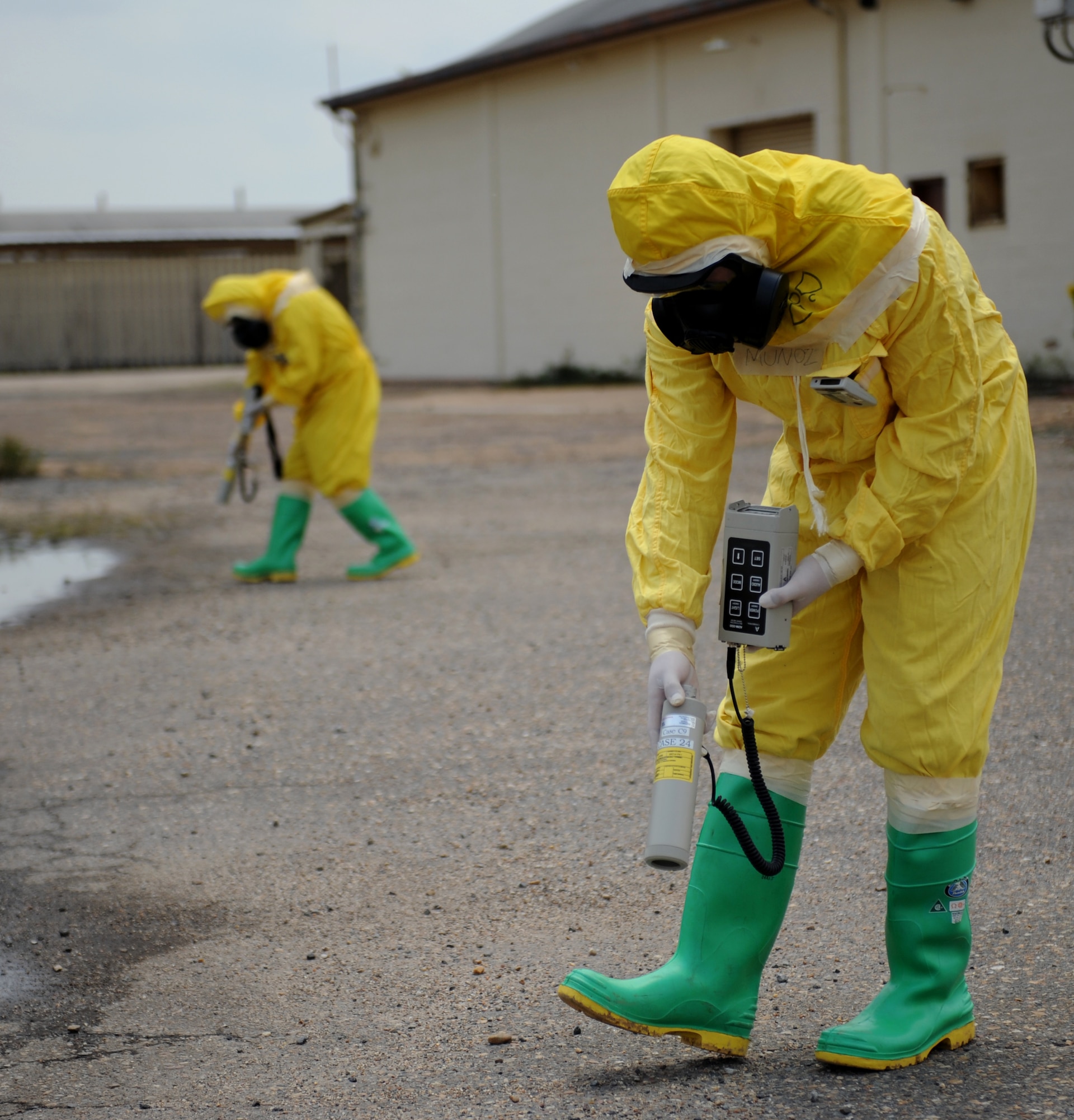 Airmen from the 2nd Civil Engineer Squadron emergency management sweep an area for radiation contamination during a joint exercise on Barksdale Air Force Base, La., May 17, 2013. Once a sweep is made and the area is clear, a decontamination zone is setup. (U.S. Air Force photo/Airman 1st Class Benjamin Gonsier) 
