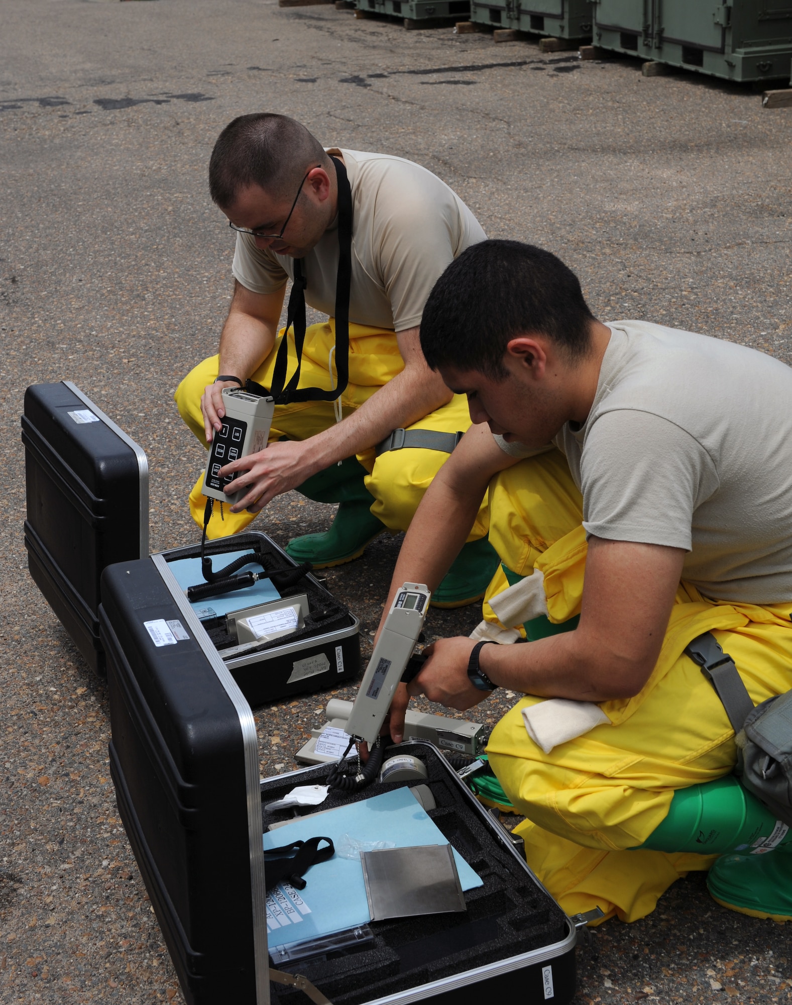 Airman Danny Camacho, front, and Airman 1st Class Jacob Buchanan, 2nd Civil Engineer Squadron emergency management, setup ADM-300 machines during a joint exercise on Barksdale Air Force Base, La., May 17, 2013. Emergency management and the 2nd Aerospace Medicine Squadron bioenvironmental use an assortment of equipment to gauge the amount of hazardous contaminants in an area. (U.S. Air Force photo/Airman 1st Class Benjamin Gonsier)
