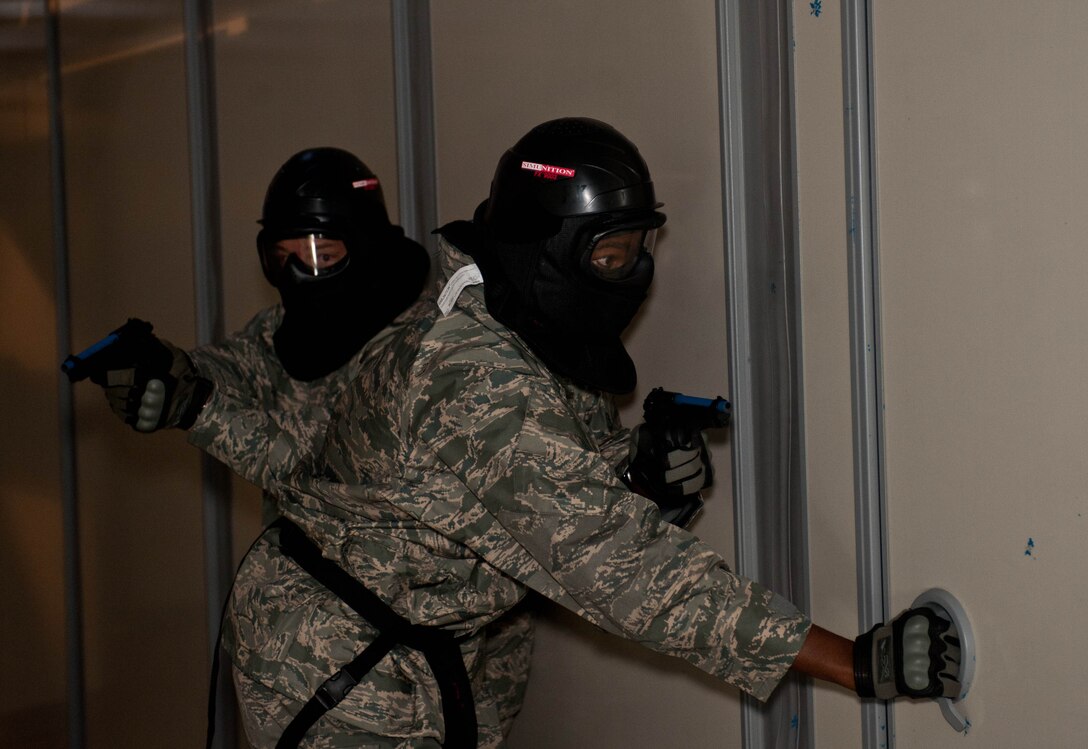 Lt. Col. Anthony Mims, 28th Logistics Readiness Squadron commander, and Senior Master Sgt. Danny Walker, 28th LRS superintendent, clear rooms in an active shooter course at the base shoot house as a part of national Police Week at Ellsworth Air Force Base, S.D., May 14, 2013. The competition was one of a variety of events held in conjunction with Police Week, a time established to recognize military and civilian police professionals for their contributions to the community. (U.S. Air Force photo by Airman 1st Class Zachary Hada/Released)