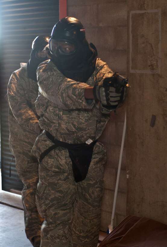 Lt. Col. Anthony Mims, 28th Logistics Readiness Squadron commander, and Senior Master Sgt. Danny Walker, 28 LRS superintendent, run through an active shooter course in a shoot house competition as part of national Police Week at Ellsworth Air Force Base, S.D., May 14, 2013. The competition promoted camaraderie between military and local law enforcement agencies, and was one of a variety of events that took place May 11-16. (U.S. Air Force photo by Airman 1st Class Zachary Hada/Released)