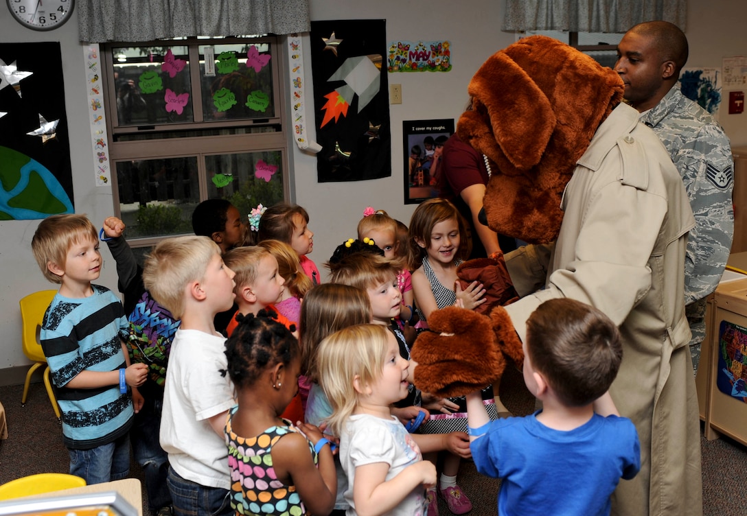 McGruff the Crime Dog and Staff Sgt. Jamari Floyd, 28th Security Forces Squadron unit training monitor, visit a class of 3 to 5-year-old students at the Child Development Center on Ellsworth Air Force Base, S.D., May 16, 2013. McGruff visited classrooms at the CDC as part of Police Week to discuss saying “no” to drugs and how to stay safe. (U.S. Air Force photo by Airman 1st Class Anania Tekurio/Released)
