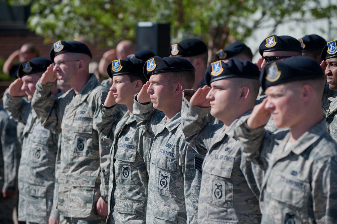 Airmen of the 28th Security Forces Squadron salute the flag during the Police Week retreat ceremony on Ellsworth Air Force Base, S.D., May 15, 2013. The National Peace Officers Memorial Day demonstrates to relatives, friends and colleagues of fallen officers that their sacrifices are never forgotten. (U.S. Air Force photo by Airman 1st Class Zachary Hada/Released)