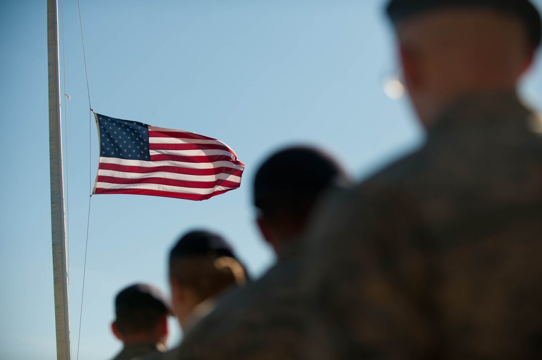Airmen of the 28th Security Forces Squadron render salutes as the flag is lowered during the Police Week retreat ceremony on Ellsworth Air Force Base, S.D., May 15, 2013. National Police Week has been a time to honor local, state and federal law enforcement members currently serving and those who have fallen officers for 47 years. (U.S. Air Force photo by Airman 1st Class Zachary Hada/Released)