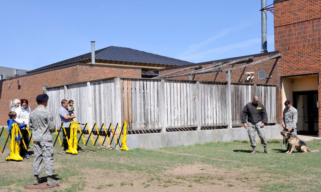 Defenders from the 28th Security Forces Squadron perform a military working dog demonstration during Police Week at Ellsworth Air Force Base, S.D., May 11, 2013. The MWD demonstration allowed attendees to see the training the dogs go through to aid in police work. (U.S. Air Force photo by Airman 1st Class Anania Tekurio/Released) 
