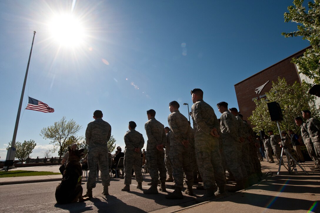Members of the 28th Security Forces Squadron stand at parade rest during the Police Week retreat ceremony on Ellsworth Air Force Base, S.D., May 15, 2013. National Police Week is a time to honor local, state and federal law enforcement officers for their dedicated service. (U.S. Air Force photo by Airman 1st Class Zachary Hada/Released)