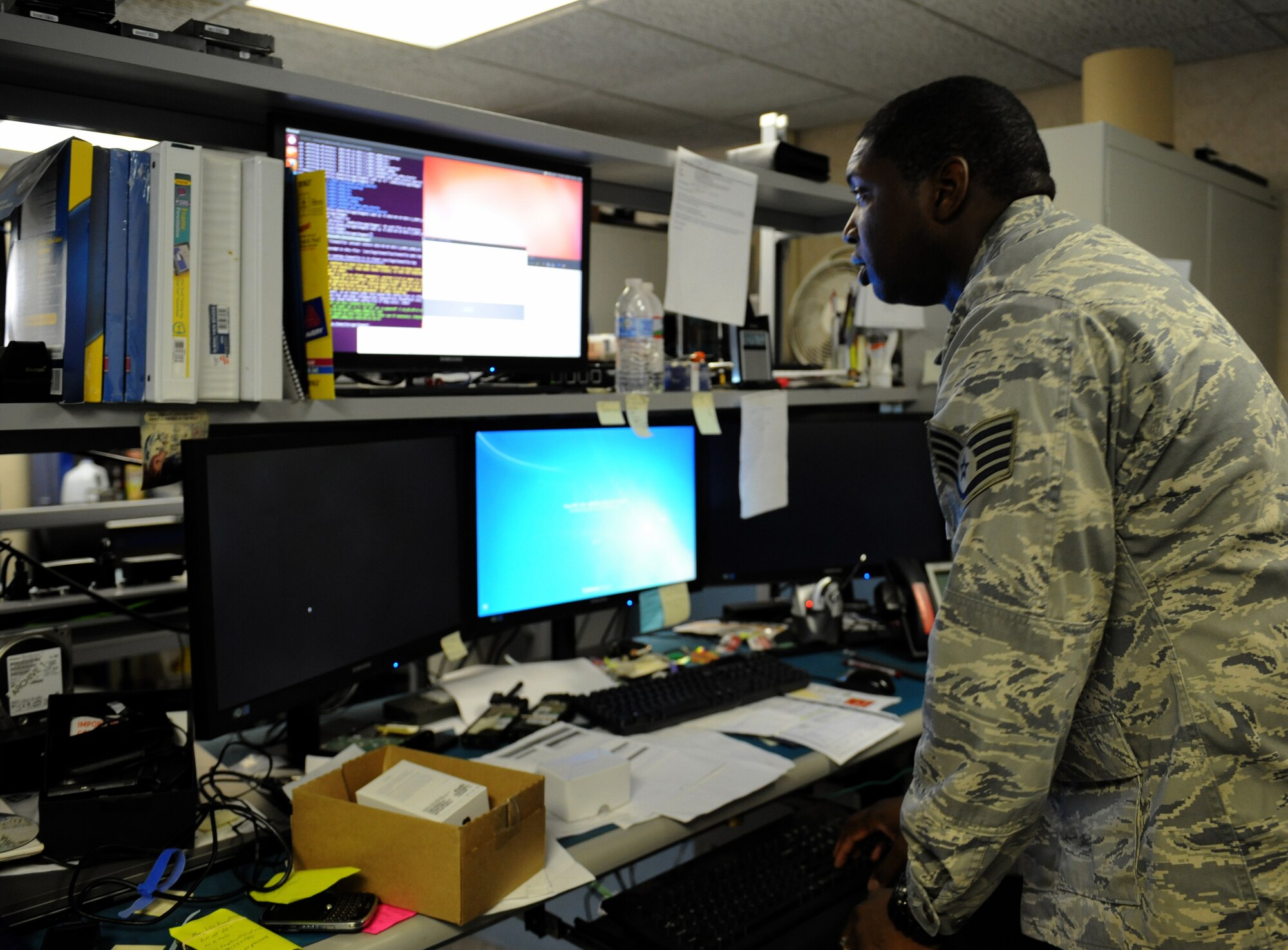 Staff Sgt. Gregory Green, 2nd Communications Squadron client service center, works on multiple computers from his desk on Barksdale Air Force Base, La., May 21, 2013. When computer systems begin to have software problems, CSC Airmen will fix the problems from their own desk. (U.S. Air Force photo/Airman 1st Class Benjamin Gonsier) 