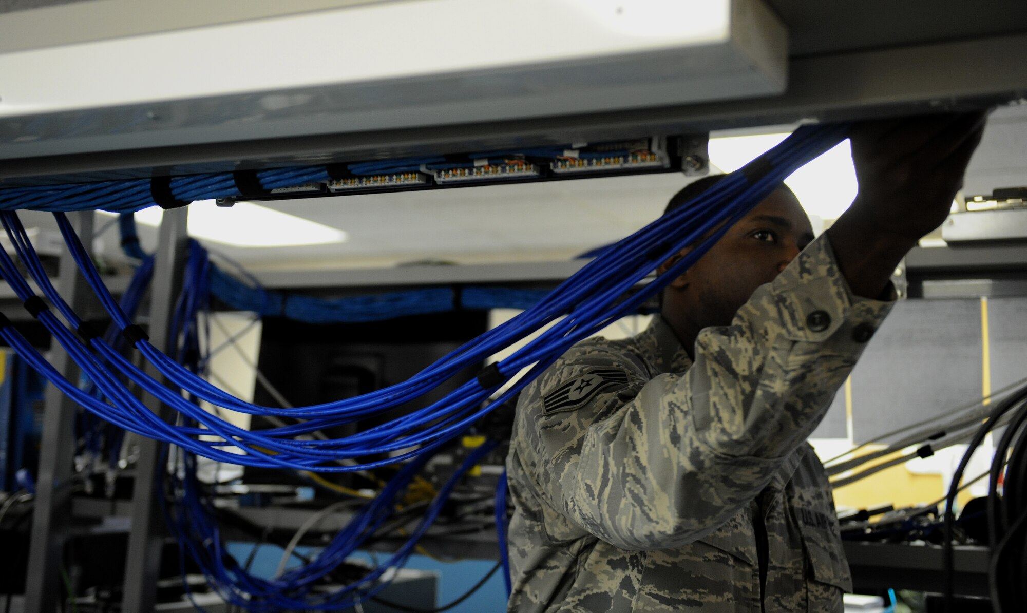 Staff Sgt. Gregory Green, 2nd Communications Squadron client service center, organizes wires on Barksdale Air Force Base, La., May 21, 2013. The CSC processes all new computers to ensure they are compliant with Air Force regulations. Computers are reformatted to have the proper software installed for Airmen to complete their mission. (U.S. Air Force photo/Airman 1st Class Benjamin Gonsier)