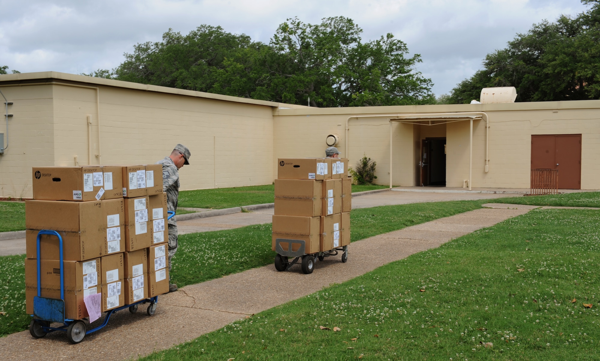 Airmen from the 2nd Communications Squadron asset management section transport computers on Barksdale Air Force Base, La., May 21, 2013. The asset management section tracks all electronics and ensures 100% accountability of all assets. (U.S. Air Force photo/Airman 1st Class Benjamin Gonsier)