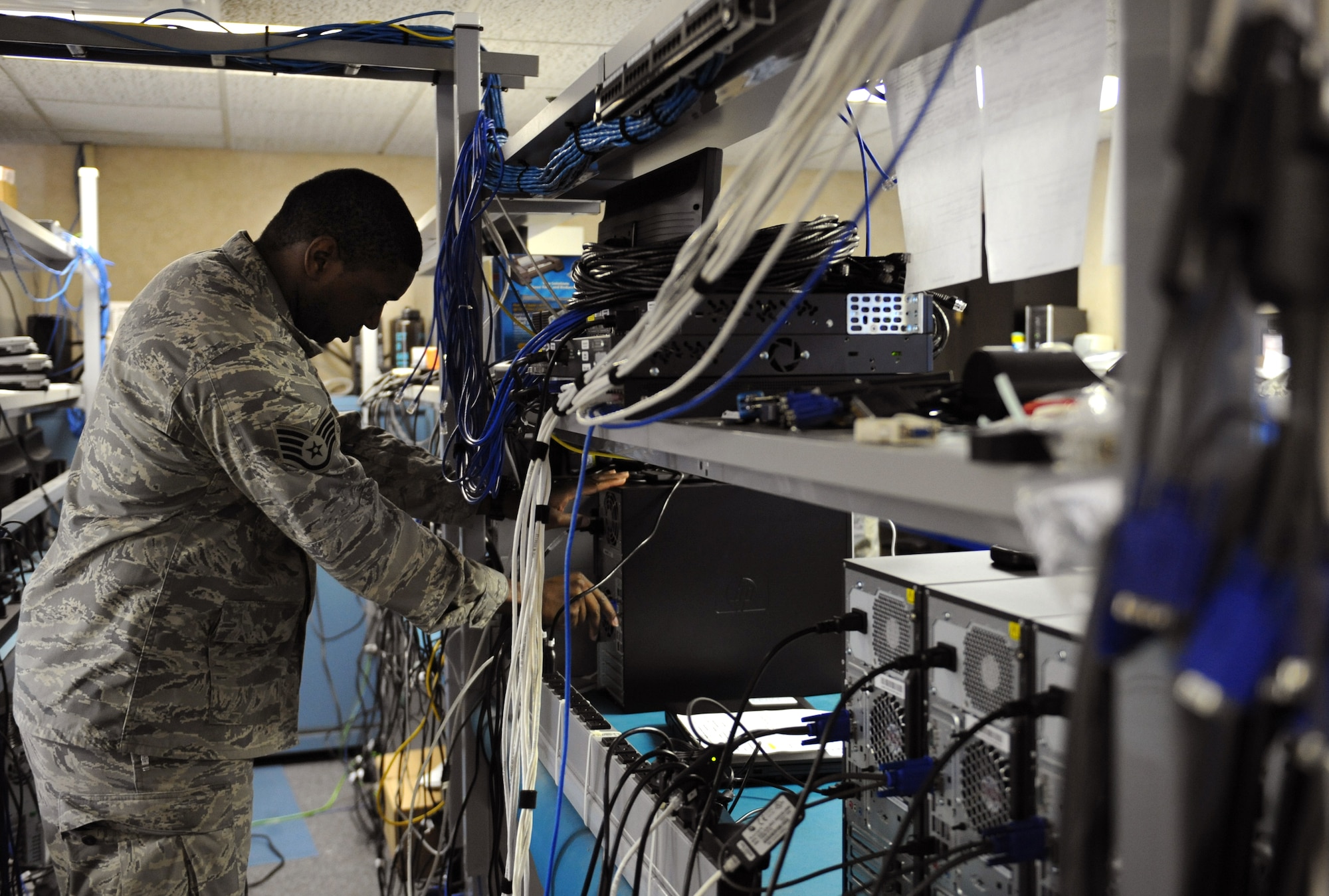 Staff Sgt. Gregory Green, 2nd Communications Squadron client service center, connects a computer to a device on Barksdale Air Force Base, La., May 21, 2013. The CSC maintains all electronics used by base personnel including computers, cell phones, radios and hard drives. (U.S. Air Force photo/Airman 1st Class Benjamin Gonsier)