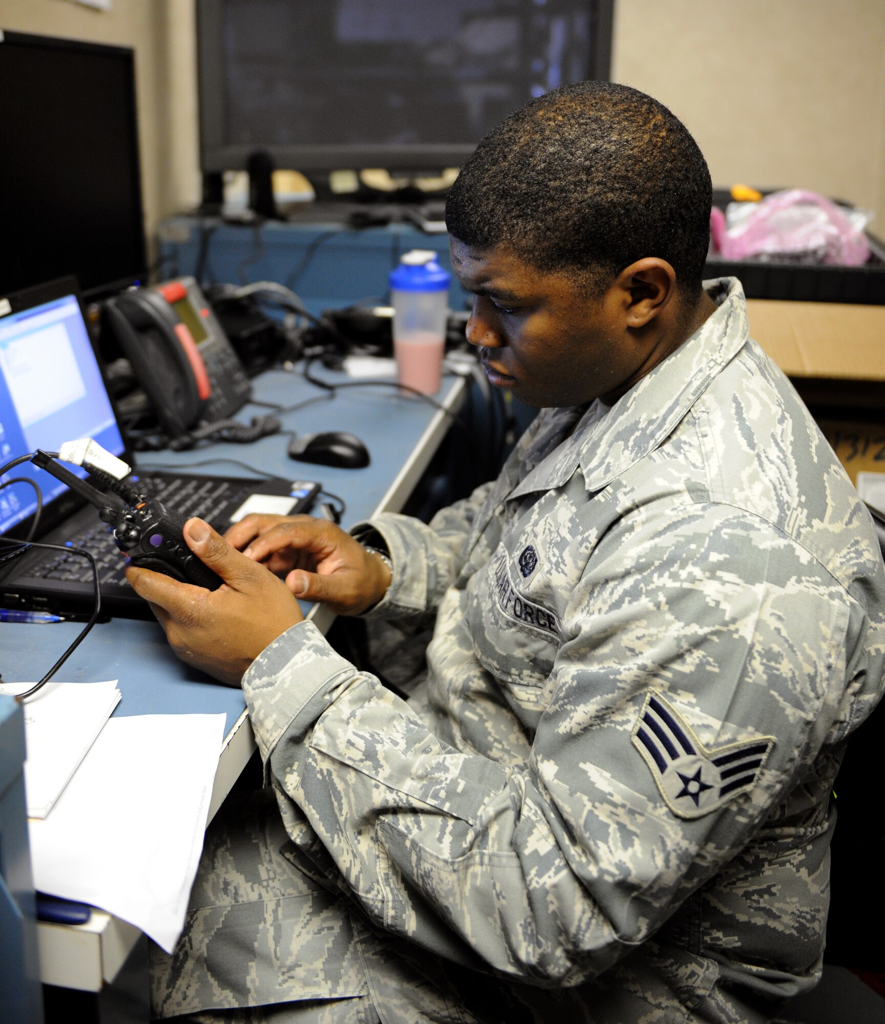 Senior Airman Darryl Elliott Jr., 2nd Communications Squadron client service center, reconfigures a radio on Barksdale Air Force Base, La., May 21, 2013.  Radios are reconfigured during exercises, to install new features or to make brand new radios compliant with organization standards. (U.S. Air Force photo/Airman 1st Class Benjamin Gonsier)