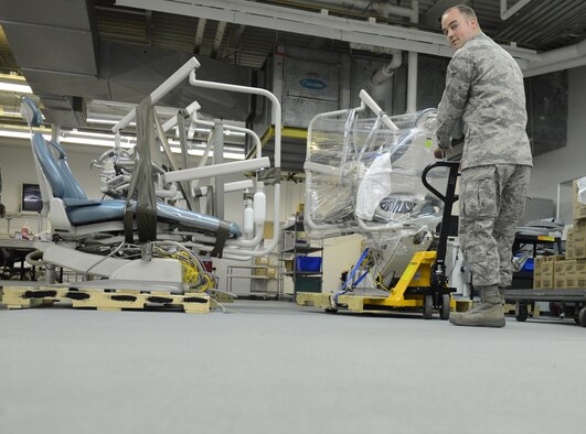 Airman 1st Class Jordan Williams, 2nd Medical Support Squadron Medical Logistics, uses a pallet jack to move a dental chair on Barksdale Air Force Base, La., May 21, 2013. Whenever equipment breaks or is replaced, Medical Logistics Airmen send the equipment to the Defense Reutilization Marketing Office. (U.S. Air Force photo/Senior Airman Micaiah Anthony)