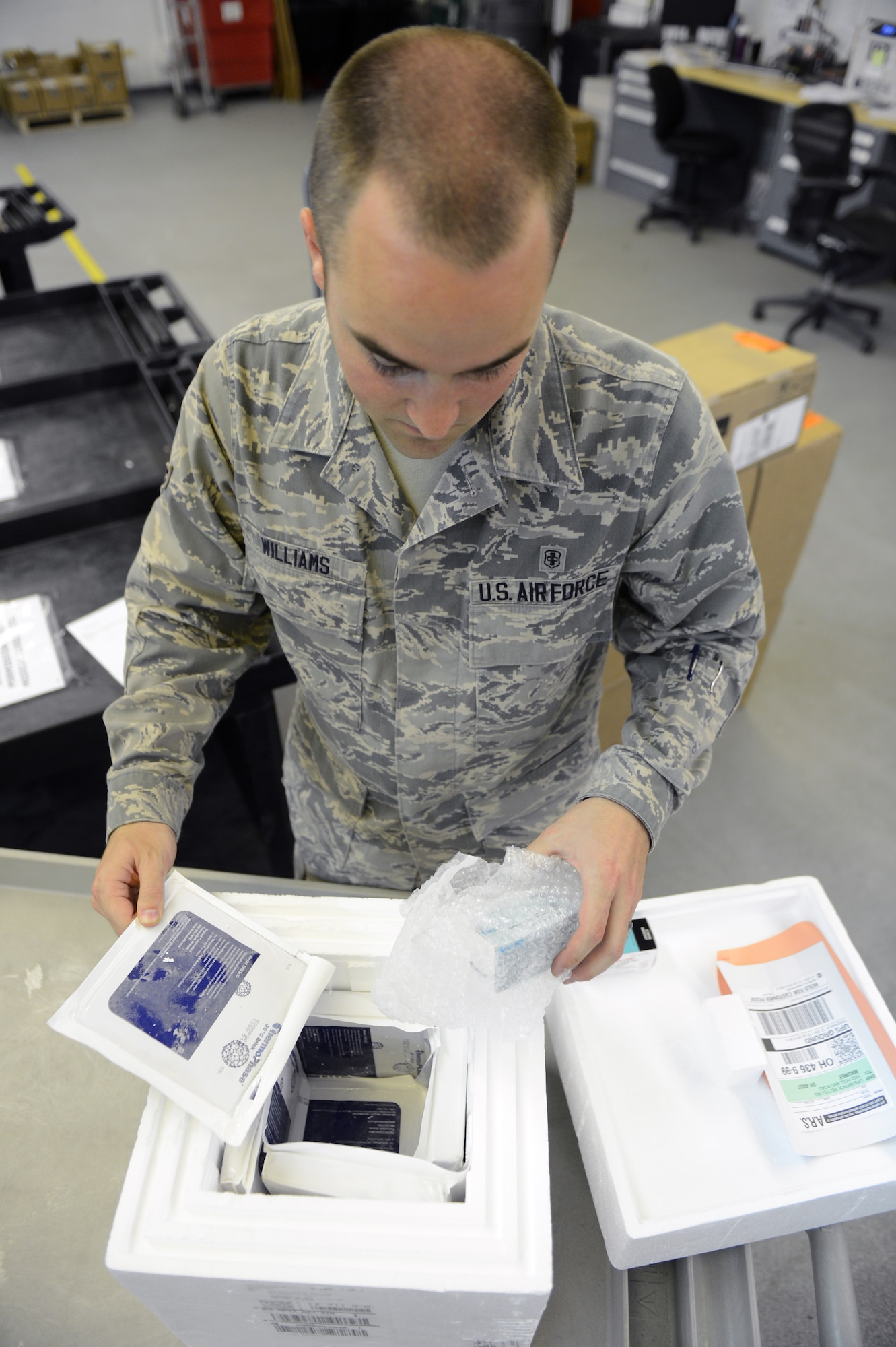 Airman 1st Class Jordan Williams, 2nd Medical Support Squadron Medical Logistics, removes medical supplies from a box on Barksdale Air Force Base, La., May 21, 2013.The Medical Logistics shop handles everything from office supplies and first aid kits to pharmaceuticals and dental chairs for the medical clinic. (U.S. Air Force photo/Senior Airman Micaiah Anthony)