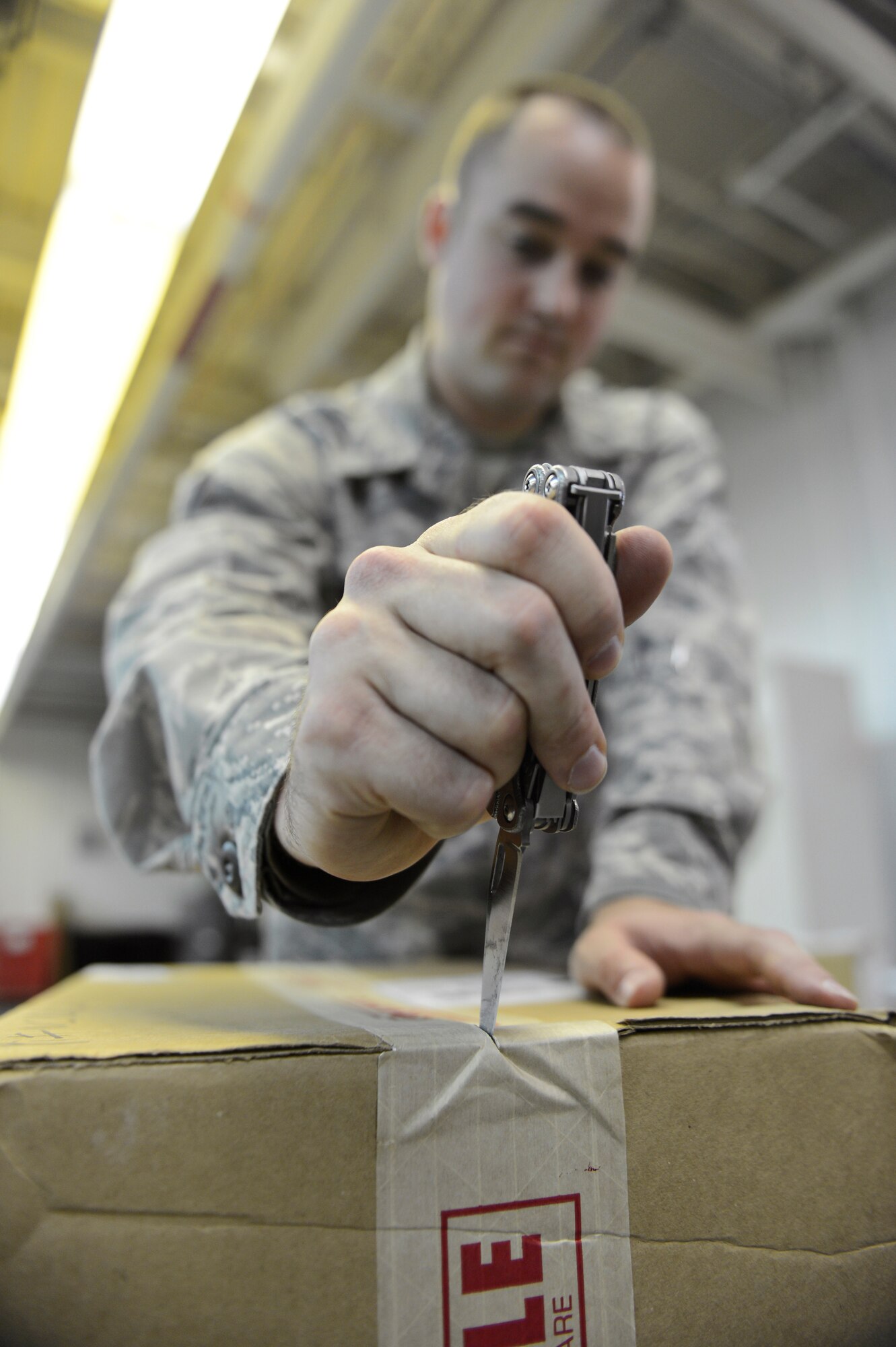 Airman 1st Class Jordan Williams, 2nd Medical Support Squadron Medical Logistics, opens a box on Barksdale Air Force Base, La., May 21, 2013. When supplies come in Medical Logistics Airmen open and check all boxes to ensure everything on the delivery receipt has been received. (U.S. Air Force photo/Senior Airman Micaiah Anthony)
