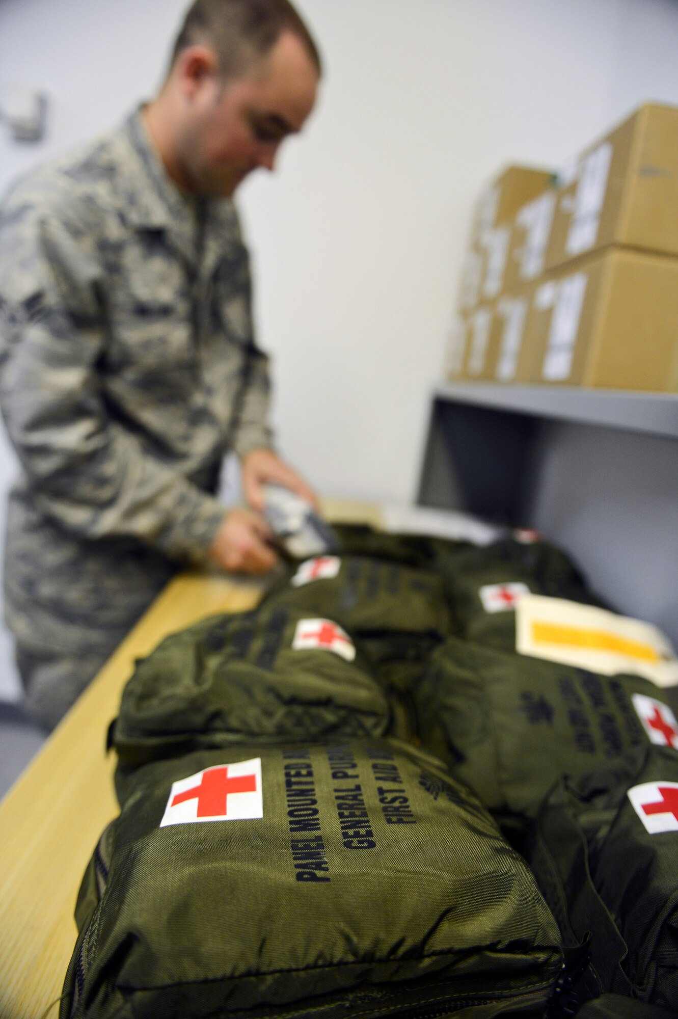 Airman 1st Class Jordan Williams, 2nd Medical Support Squadron Medical Logistics, inspects a first-aid kit on Barksdale Air Force Base, La., May 21, 2013. Medical Logistics Airmen inspect the kits to ensure its contents are not outdated and that all the supplies are there. Once checked, the first aid kits are placed on aircraft for aircrew to use. (U.S. Air Force photo/Senior Airman Micaiah Anthony)