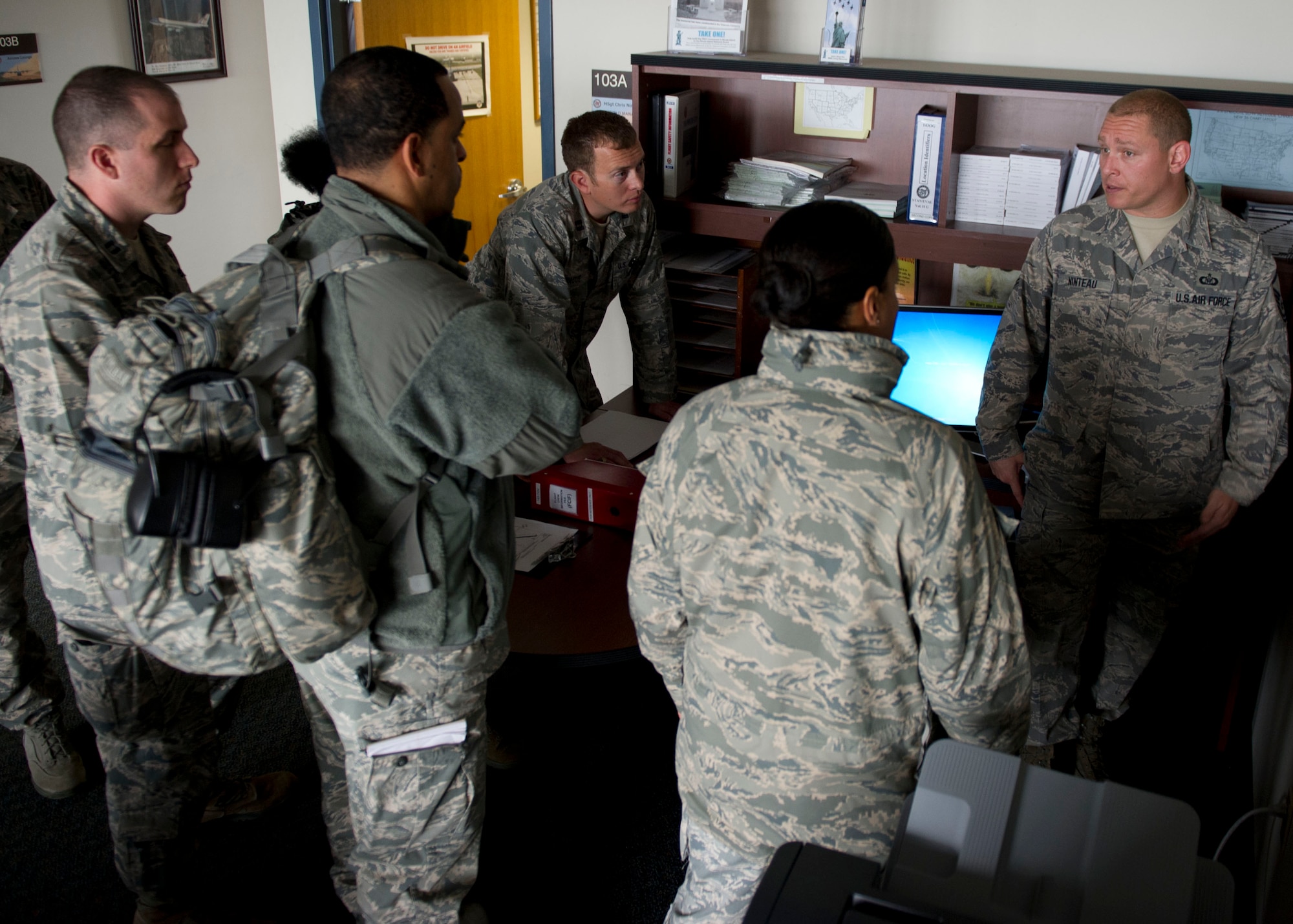 QUONSET POINT AIR NATIONAL GUARD STATION, R.I. -- Master Sgt. Christopher Ninteau, 143rd Airlift Wing airfield manager, speaks to members of the 818th Contingency Response Group during the 818 CRG-143 AW exercise at Quonset Point Air National Guard Station, RI, May 14, 2012. The training included C-130 Hercules operations, static loading/unloading, day and night engine running on-load/offload, night vision gear engine running on-load/offload, combat offloads, airdrop rigging, maintenance familiarization, drop zone recovery training, night vision gear marshaling training, full spectrum communications, and integrated command and control with the 143rd AW operations. (U.S. Air Force photo by Staff Sgt. Gustavo Gonzalez) 
