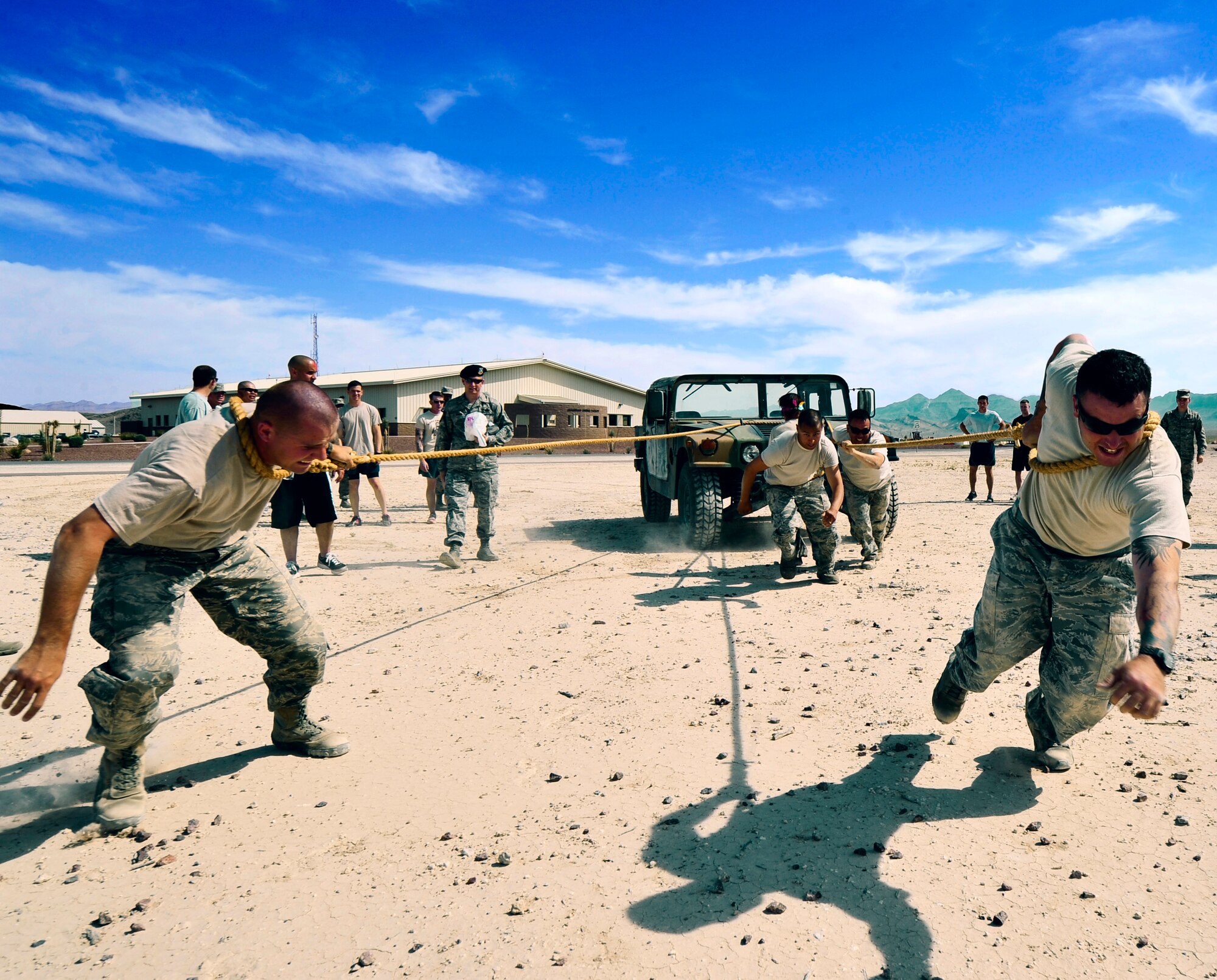 LAS VEGAS, Nev. -- 799th Air Base Group members pull a Humvee during the Security Forces Challenge, May 16, 2013.  The competition was the final event celebrating National Police Week and included events such as a team carry, deuce low crawl, weapon skills, and a Humvee pull. National Police Week takes place annually to honor the service and sacrifice of civilian and military law enforcement members.  (U.S. Air Force photo by Staff Sgt. D.H./Released)