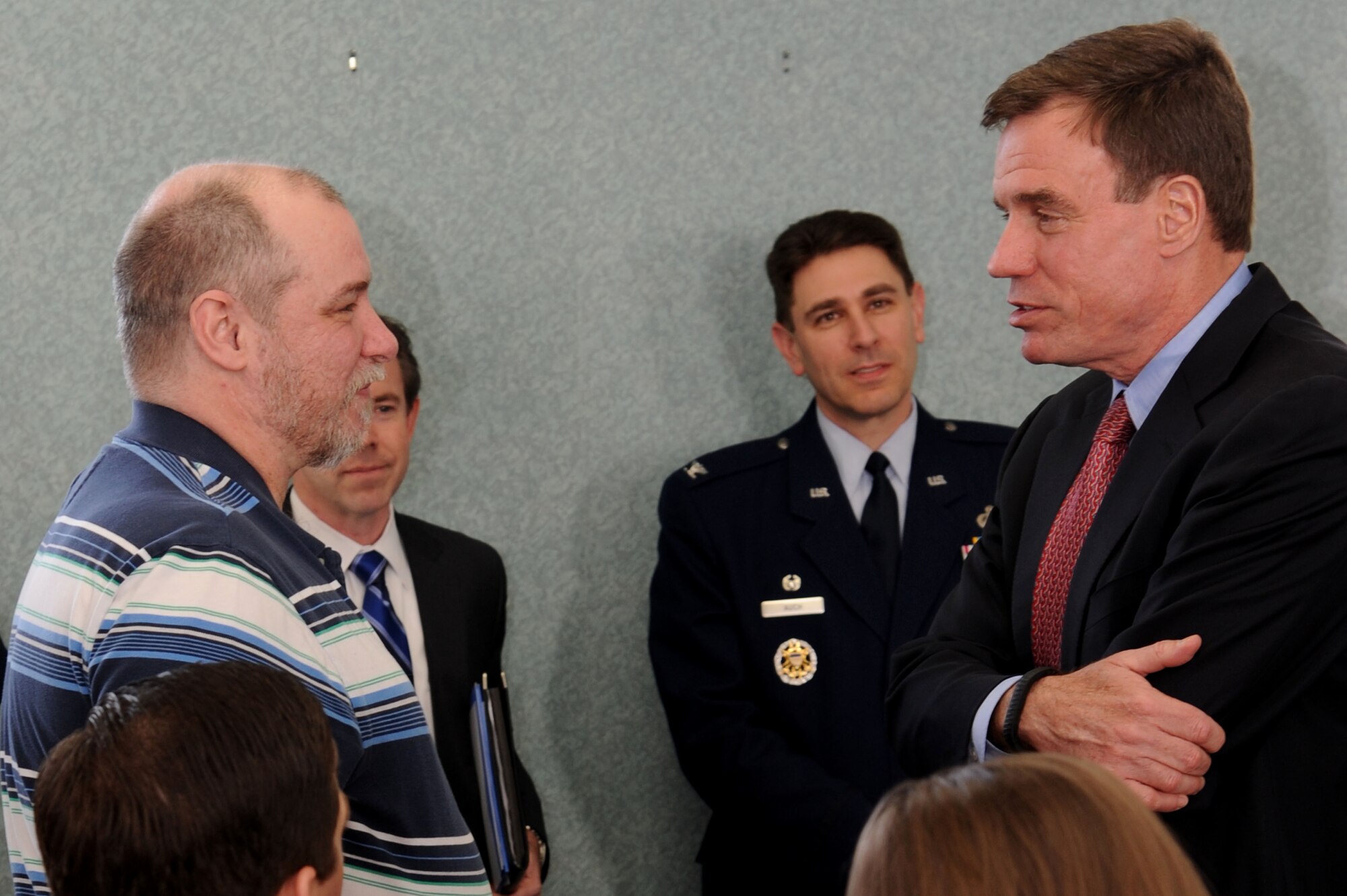 U.S. Sen. Mark Warner (right) speaks to John David Millan (left), during a medal presentation for retired U.S. Air Force Senior Master Sgt. John T. Millan at Hampton Veterans Affairs Hosptial in Hampton, Va., March 15, 2013.  Sen. Warner presented the medals to Millan's family for his service in the Vietnam and Korean wars. (U.S. Air Force photo by Airman 1st Class Victoria H. Taylor/Released)