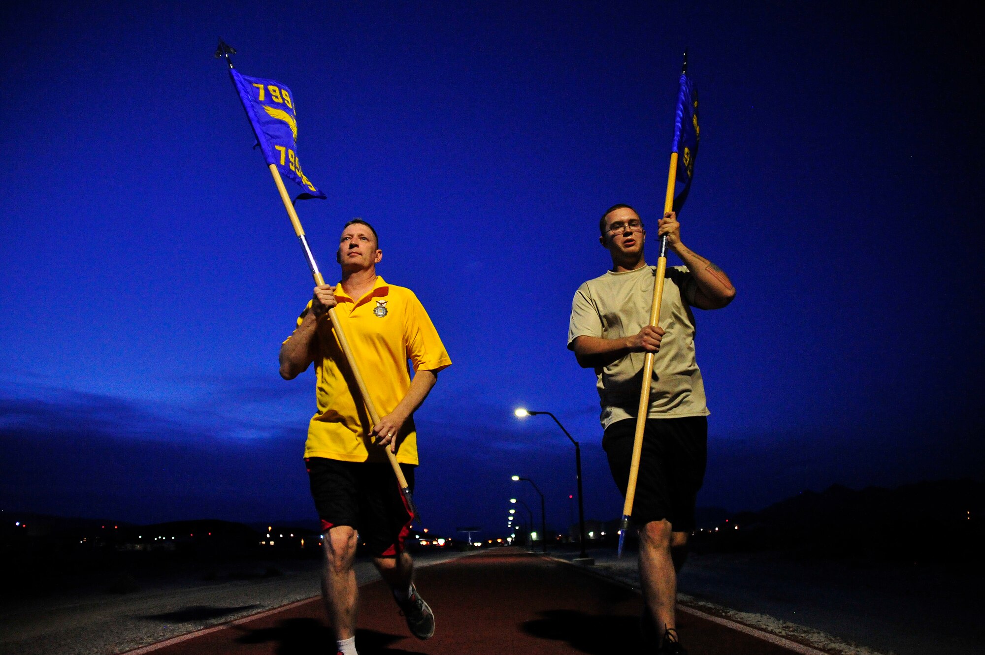 LAS VEGAS, Nev. -- Airmen from the 799th Security Forces Squadron and 99th Ground Combat Training Squadron participate in a 24-hour run to recognize the service and sacrifice of all U.S. law enforcement personnel during National Police Week, May 15, 2013. Airmen ran 30-minute shifts during the event before passing their guidons on to fellow Airmen to do the same. (U.S. Air Force photo by Senior Master Sgt. P.H./Released)