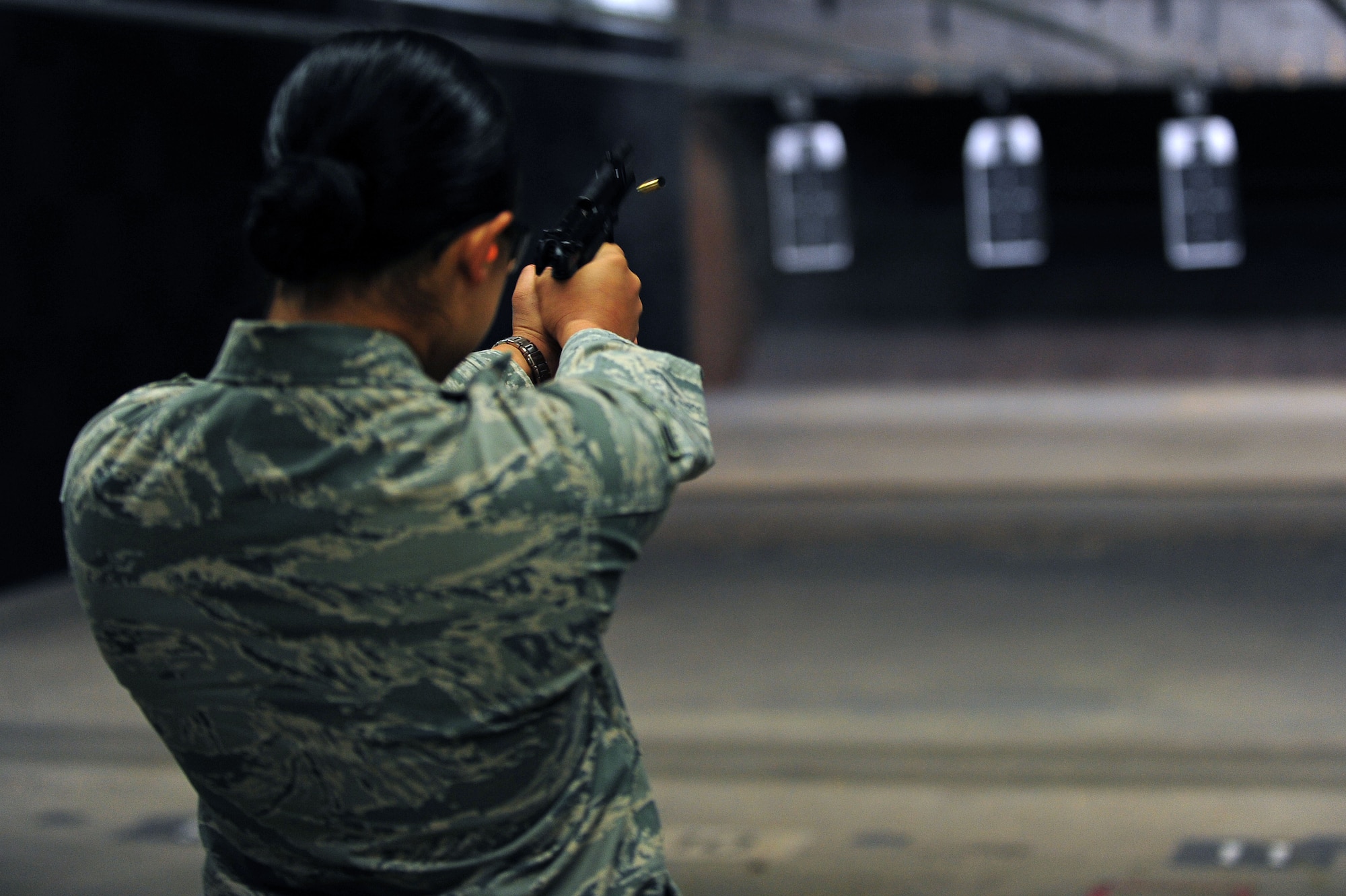 U.S. Air Force Airman 1st Class Samantha Overdear, 4th Contracting Squadron contract specialist, fires an M9 pistol during an excellence-in-competition (EIC) pistol match on Seymour Johnson Air Force Base, N.C., May 14, 2013. The EIC match allows any member of the Armed Forces to participate and compete individually for points toward an EIC badge. (U.S. Air Force photo by Airman 1st Class John Nieves Camacho/Released)
