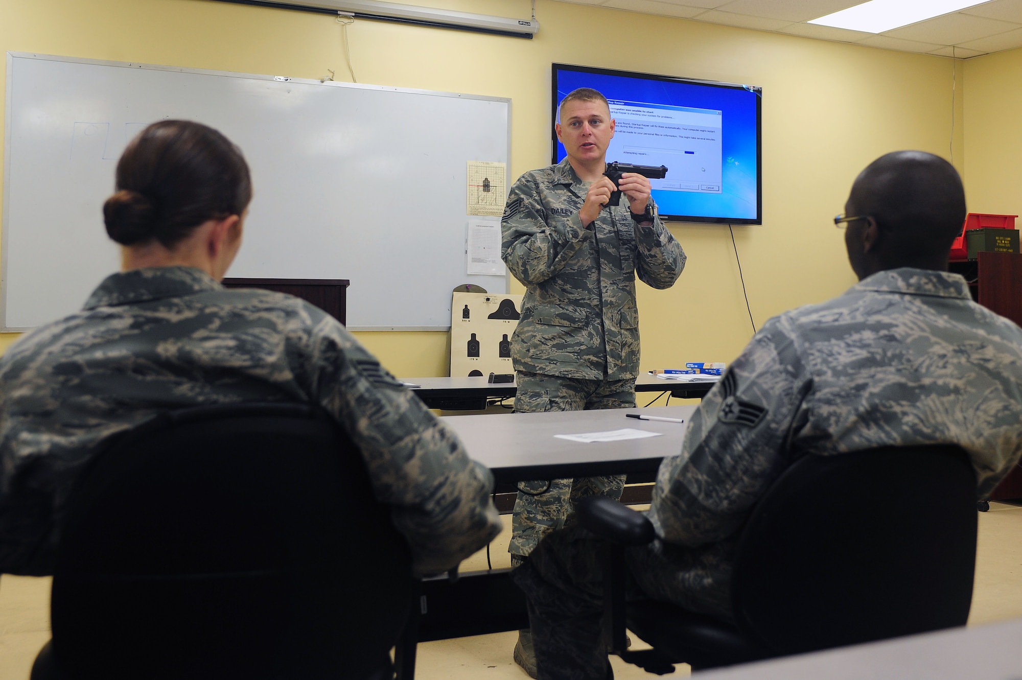 U.S. Air Force Tech. Sgt. Tommy Dailey, 4th Security Forces Squadron combat arms assistant NCO in-charge, conducts a safety briefing for the M9 pistol prior to the start of an excellence-in-competition (EIC) pistol match on Seymour Johnson Air Force Base, N.C., May 14, 2013. The briefing informed participants on proper safety procedures and weapon handling. (U.S. Air Force photo by Airman 1st Class John Nieves Camacho/Released)