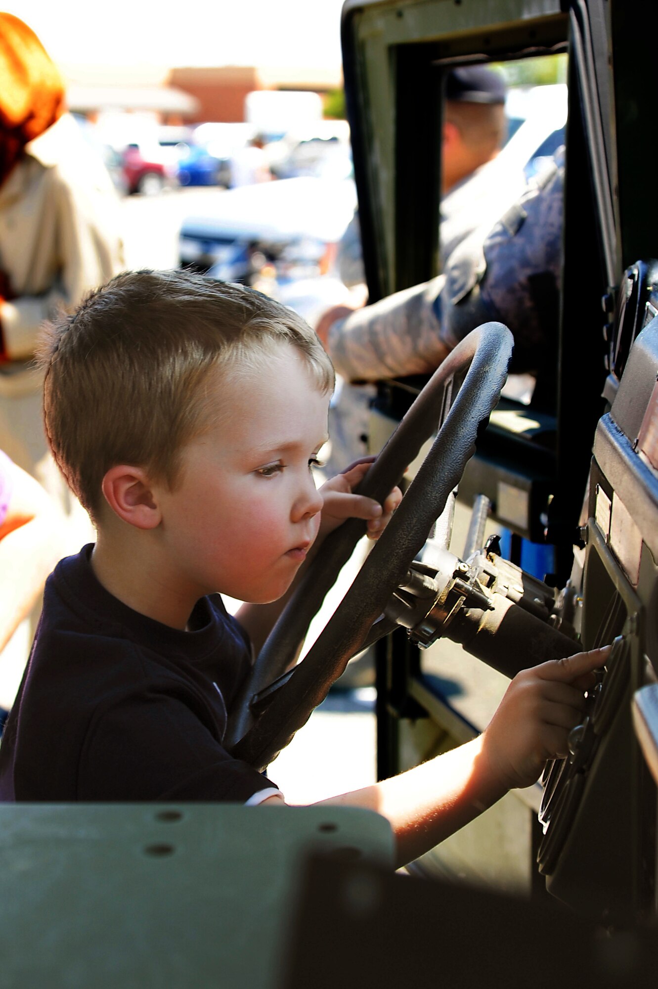 Mason Gilbert, 4, son of Maj. Myles Gilbert, Air Combat Command program manager, explores the interior of an armored Humvee at Langley Air Force Base, Va., May 16, 2013. The armored Humvee was just one piece of equipment on display during Police Week’s demonstration event, which also included gear and K-9 demonstrations. (U.S. Air Force photo by Airman 1st Class Victoria H. Taylor/Released)
