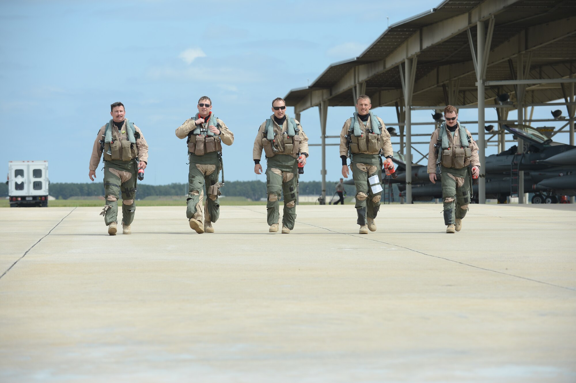 U.S. Air Force Capt. Hugh Walker, Maj. Brian Grossweiller, Capt. Jason Blodzinski, Capt. Joe Schenkel, and Capt. Patrick McAndrew, 77th Fighter Squadron pilots, depart the Shaw AFB flightline after returning from Afghanistan Apr. 13, 2013.  Capt. Walker was recently awarded the Lt. Col. Anthony C. Shine Award and the Robbie Risner Award for his contributions as a fighter pilot and weapons officer.  (U.S. Air Force photo by Airman 1st Class Krystal M. Jeffers/Released)