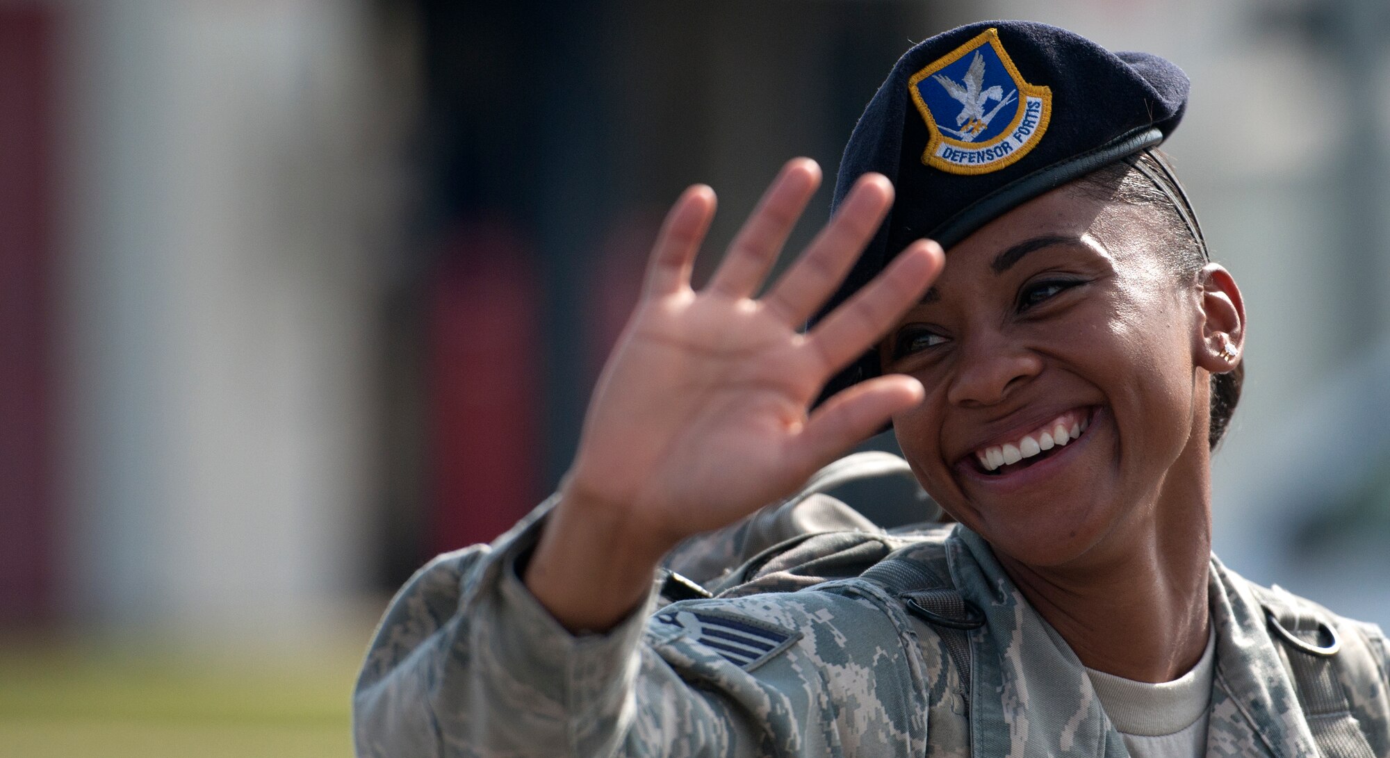 ALTUS, Okla. – Staff Sgt. Chrystal Carter, 97th Security Forces Squadron flight sergeant, waves to spectators while marching in the Armed Forces Day Parade, May 18. The event welcomes the opportunity to pay special tribute to the men and women of the armed forces as well as celebrating the unification of all the military services. Armed Forces Day is celebrated annually on the third Saturday of May. (U.S. Air Force photo by Senior Airman Jesse Lopez / Released)