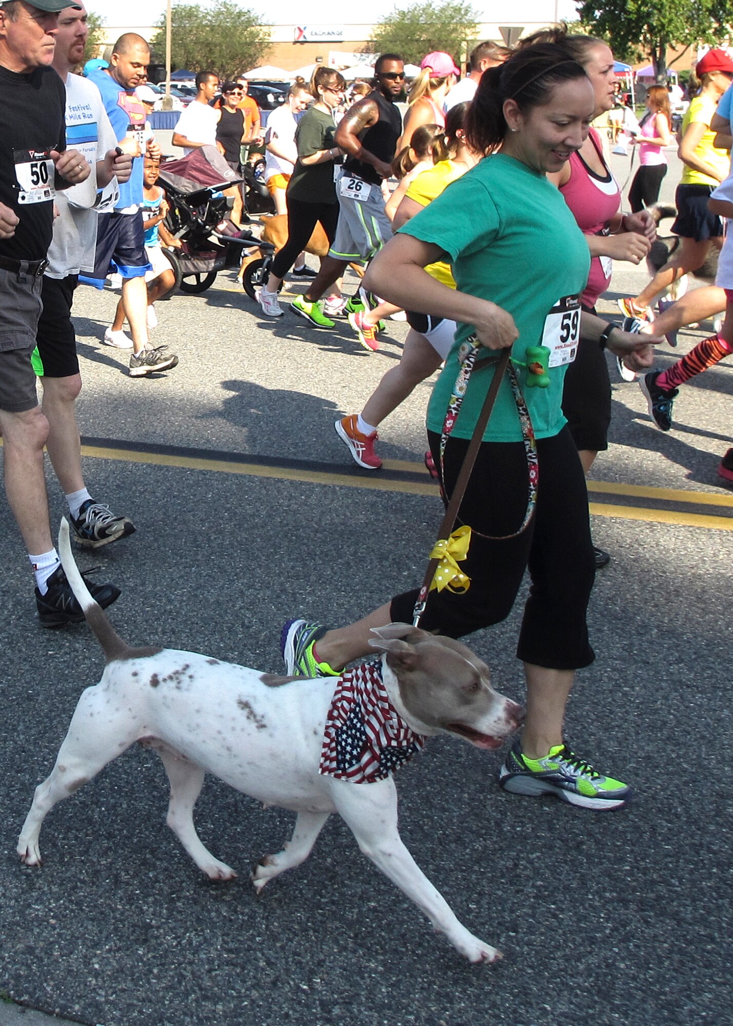 U.S. Air Force Master Sgt. Abigail Esparza, 23d Medical Support Squadron pharmacy flight chief, participates in the 5K-9 Fun Run and Walk with her dog at Moody Air Force Base, Ga., May 18, 2013. The proceeds from the 5K helped raise more than $5,000 to benefit the Humane Society. (U.S. Air Force photo by Senior Airman Eileen Meier/Released)