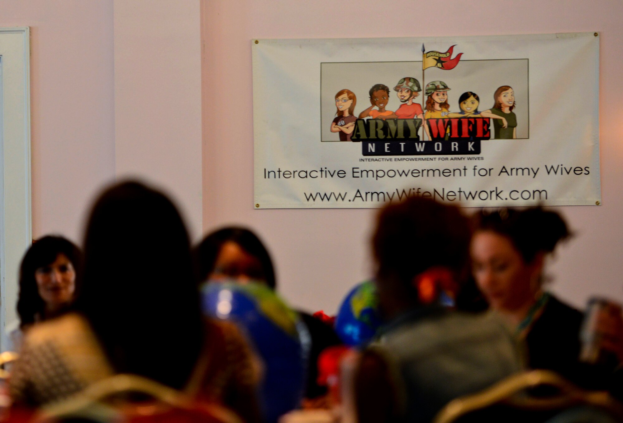 Spouses of U.S. Service members interact during the Army Wife Network's "Spouse Field Exercise" at the post club at Fort Eustis, Va., May 17, 2013. The event not only provided information for spouses, but also focused networking opportunities and to show participants they are not alone.  (U.S. Air Force photo by Airman 1st Class R. Alex Durbin/Released)