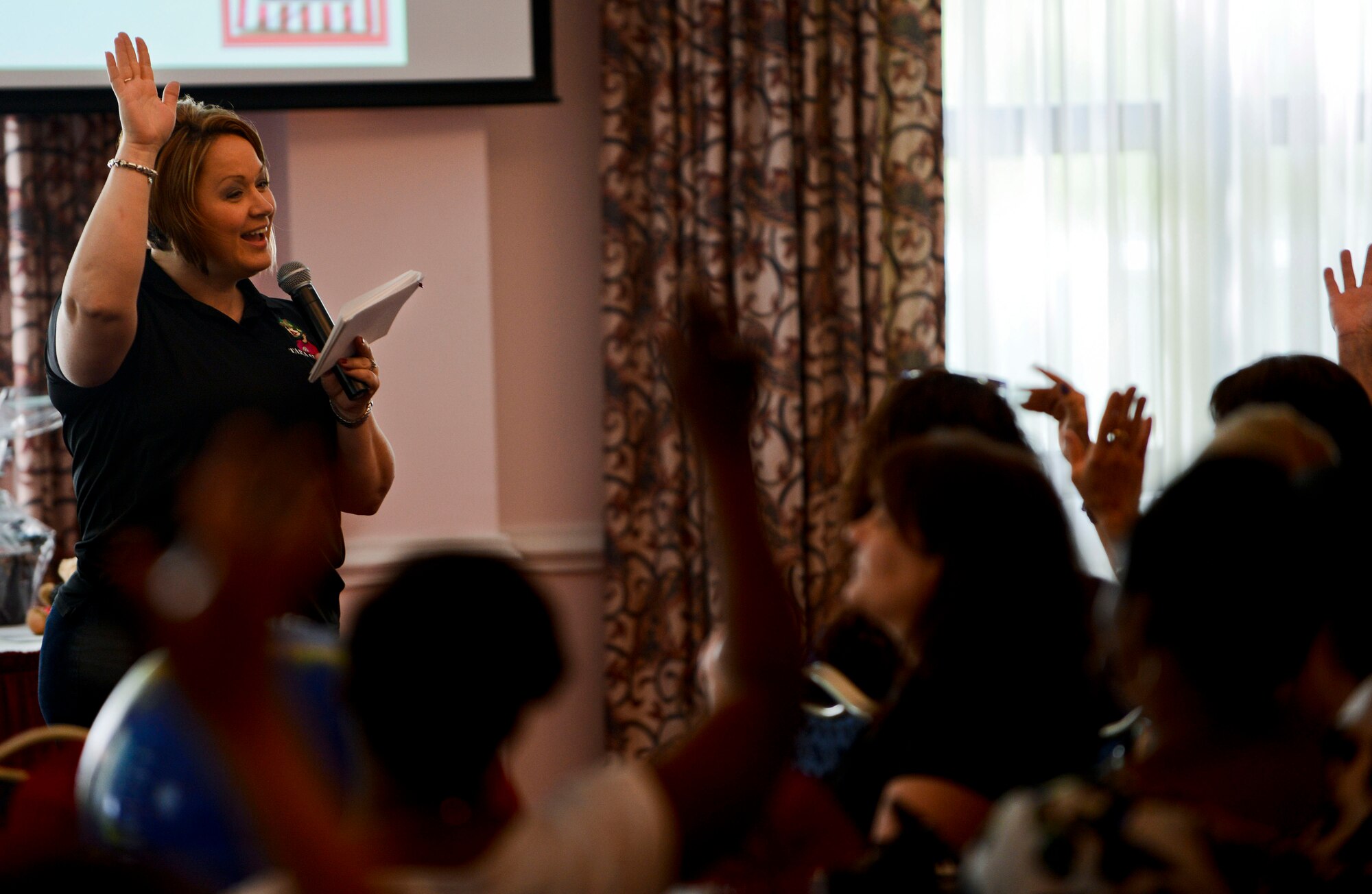 Tara Crooks, co-founder of Army Wife Network and co-author of "1,001 Things to Love About Military Life," interacts with spouses during AWN's "Spouse Field Exercise" at the post club at Fort Eustis, Va., May 17, 2013. The field exercises were designed to aid military families by offering military-life survival tips, practical military family resources, information booths, resource bags and a professional financial advisor to share tips to take charge of family finances and set goals. (U.S. Air Force photo by Airman 1st Class R. Alex Durbin/Released)