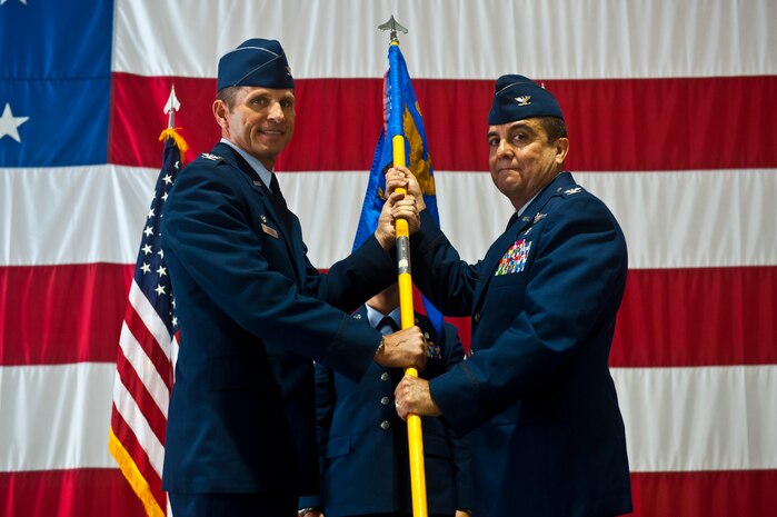 Col. Guillermo Tellez, 99th Medical Group commander, accepts the MDG’s guidon from Col. Barry Cornish, 99th Air Base Wing commander, during the 99th MDG change of command ceremony May 17, 2013, inside the Thunderbird Hangar at Nellis Air Force Base, Nev. The 99th MDG provides medical care to Department of Defense beneficiaries and veterans to ensure maximum wartime readiness and combat capability. (U.S. Air Force photo/Senior Airman Brett Clashman)