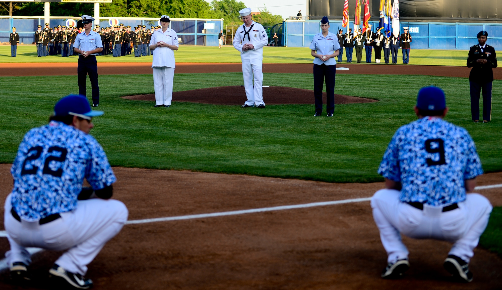 Members from each branch of service prepare to throw the first pitch during the Norfolk Tides Armed Forces Night at Harbor Park in Norfolk, Va., May 17, 2013. The Tides Armed Forces Night has been a tradition for 18 years, paying tribute to the men and women of the U.S. Army, Air Force, Coast Guard, Navy and Marines for their dedication and service to the nation. (U.S. Air Force photo by Senior Airman Kayla Newman/Released)