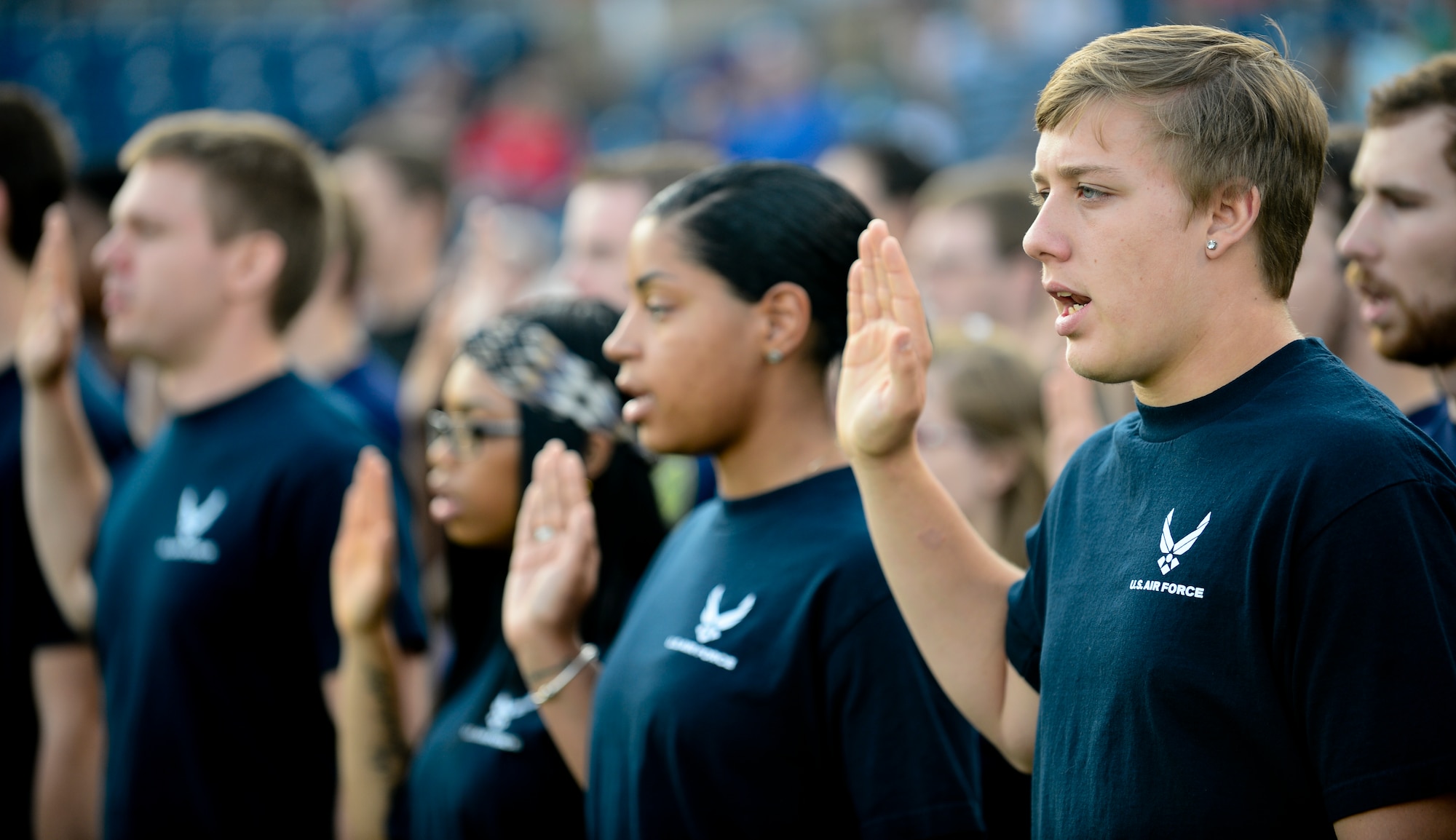 A group of young men and women in the Delayed Entry Program volunteer to serve the U.S. military by taking the Oath of Enlistment during the Norfolk Tides Armed Forces Night at Harbor Park in Norfolk, Va., May 17, 2013. U.S. Army Maj. Gen. Bryan Watson, Joint Staff J7 Joint Force Development vice director, administered the oath. (U.S. Air Force photo by Senior Airman Kayla Newman/Released)